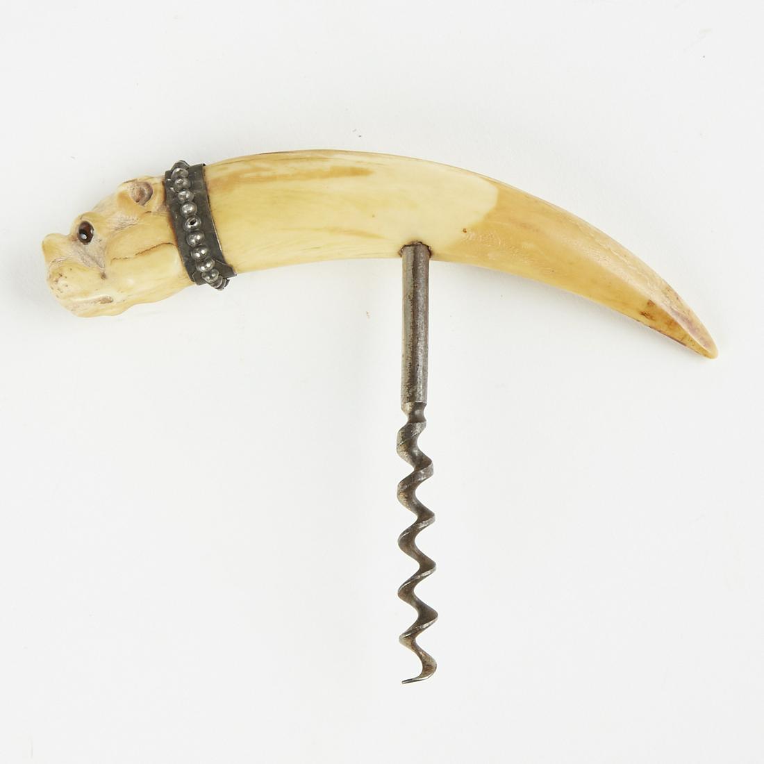 Early Carved Boar Tusk Bulldog Head Corkscrew: Early carved boar tusk in the form of a bulldog head with a jeweled eye and metal collar constructed into a corkscrew. Height: 3 3/4 in x width: 4 1/2 in x depth: 3/4 in