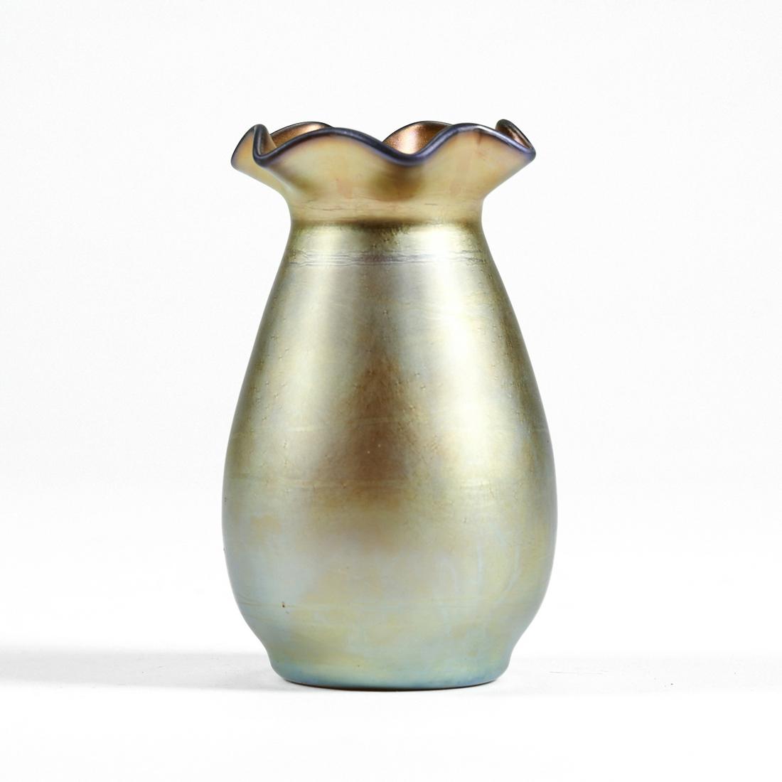 Aurene Steuben Art Glass Vase: Frederick Carder (English, 1863-1963) for Steuben Glass Works, Corning, New York, USA. Small gold Aurene iridescent art glass vase with a pale gold surface and a ruffled rim. Marked with the early eng