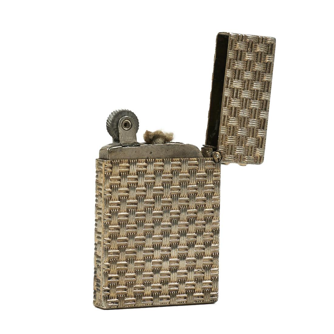 Tiffany & Co. Sterling Silver Flint Wheel Lighter: Tiffany & Co., United States. One early twentieth century sterling silver flint wheel lighter. The flint wheel turns. Impressed makers mark "Tiffany & Co" and "Sterling" along the 