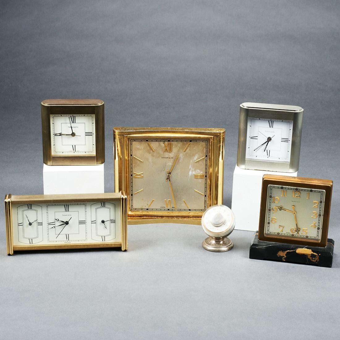 Grp: 6 Tiffany & Co. Desk Clocks: Group of five Tiffany & Co. desk clocks. With one desk thermometer housed in a sterling silver Tiffany & Co. body. Height ranges from 3 in to 6 1/4 in; width ranges from 2 in to 8 1/4 in; depth ranges