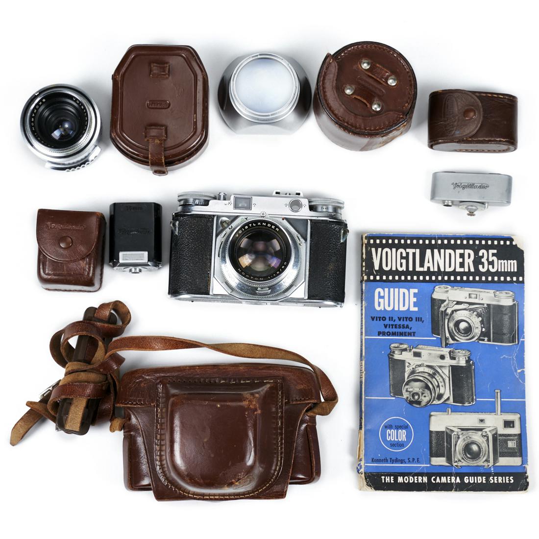Voigtlander Prominent Camera Body & Accessories: Voigtlander Prominent camera body, No. B 37226. With accessories including a Voigtlander Nokton 1:1,5/50 camera lens; a Voigtlander Skoparon 1:3.5/35 camera lens; a hood numbered 310/47; one leather c