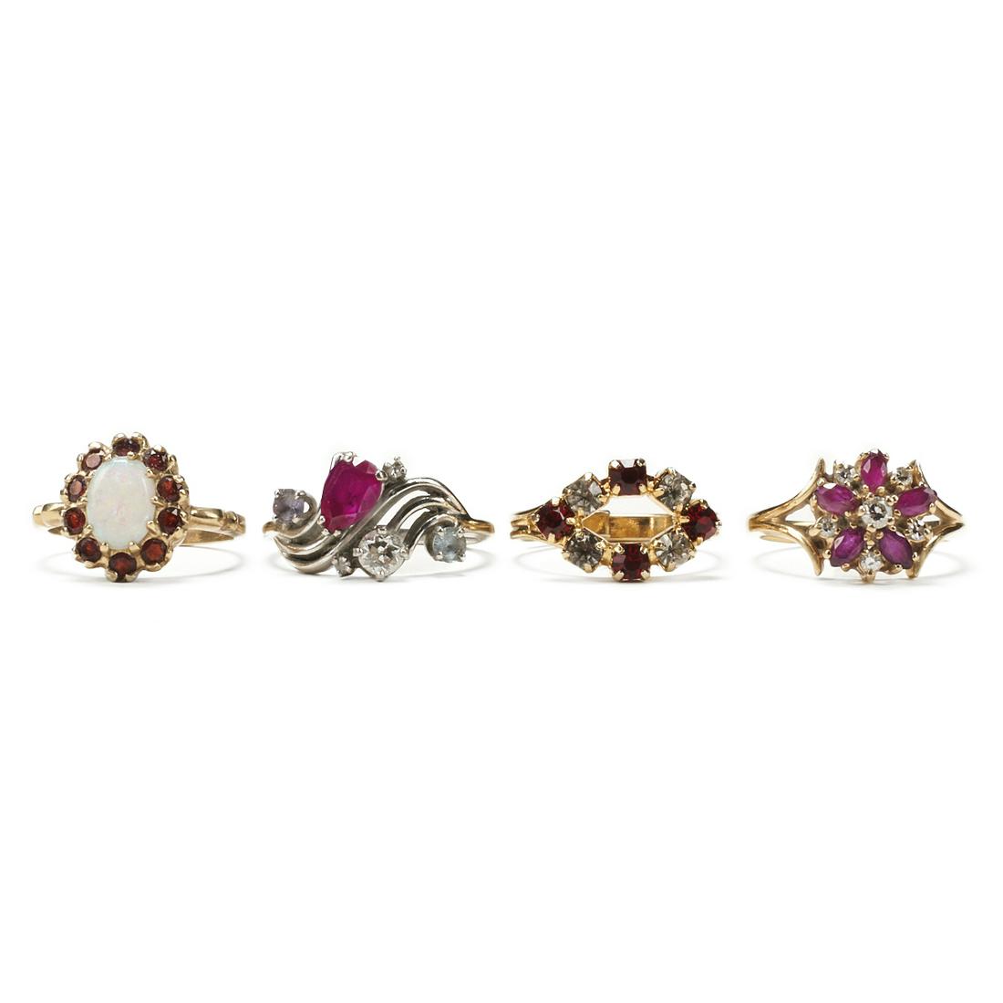 Grp: 4 Vintage Gold Colored Gemstone Rings: Group of four colored gemstone rings, including one 14K yellow gold opal and garnet ring, size 5.5 US, and marked "14K" along the inside of the band; one 14K white gold marquise shaped ruby 