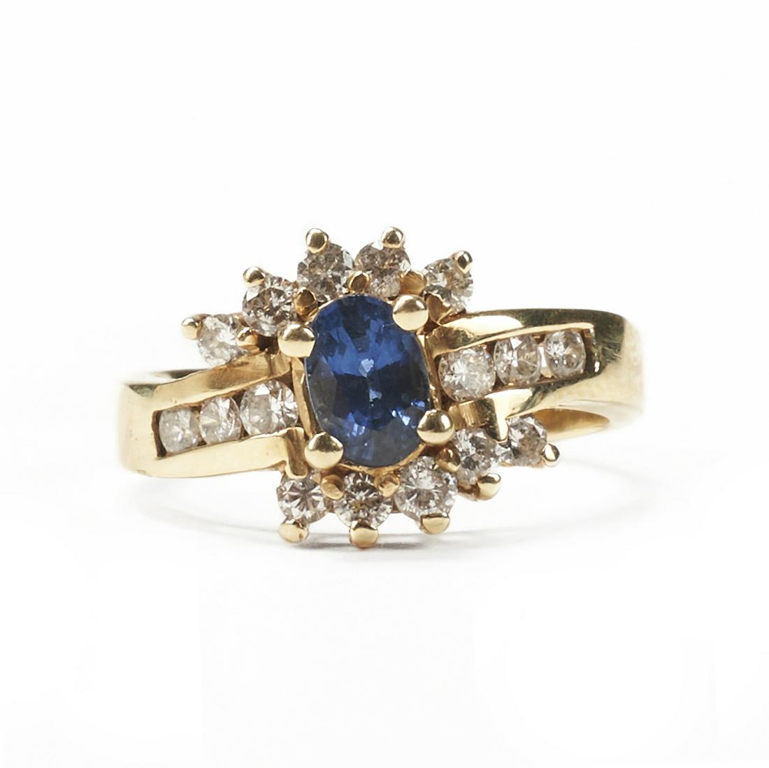 14K Gold Sapphire Diamond Ring - Vintage: 14K yellow gold blue sapphire and diamond ring. The blue sapphire is oval, medium, strong, blue, and measures 6.08 mm by 4.16 mm by 3.37 mm, weighing 0.78 carats total. There are sixteen round brillia