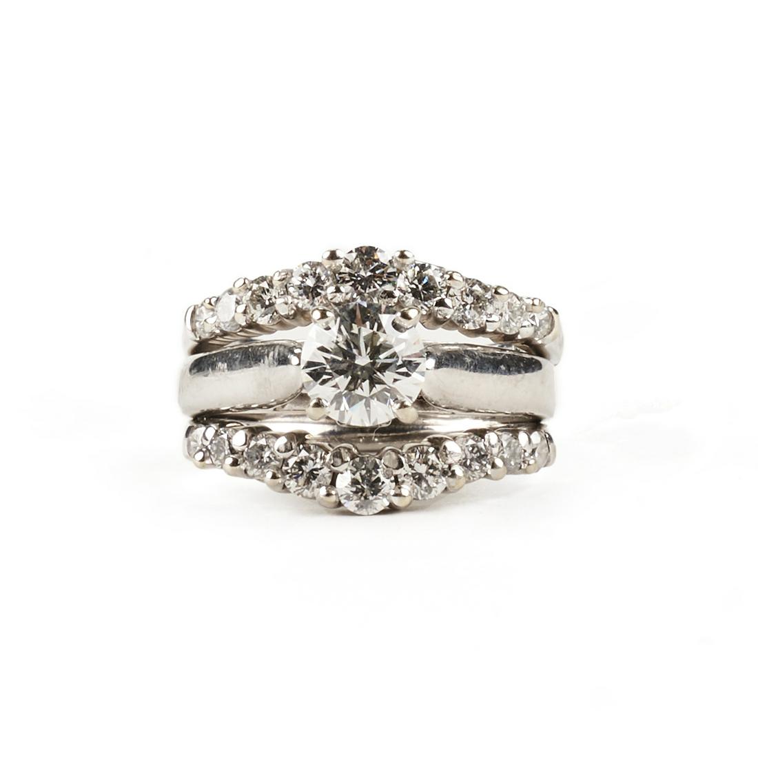 14K White Gold Diamond Wedding Set Ring: 14K white gold three ring diamond wedding set, soldered together as one ring. The central engagement ring centers a round brilliant cut diamond with excellent polish and symmetry of H color, of CS1 cl
