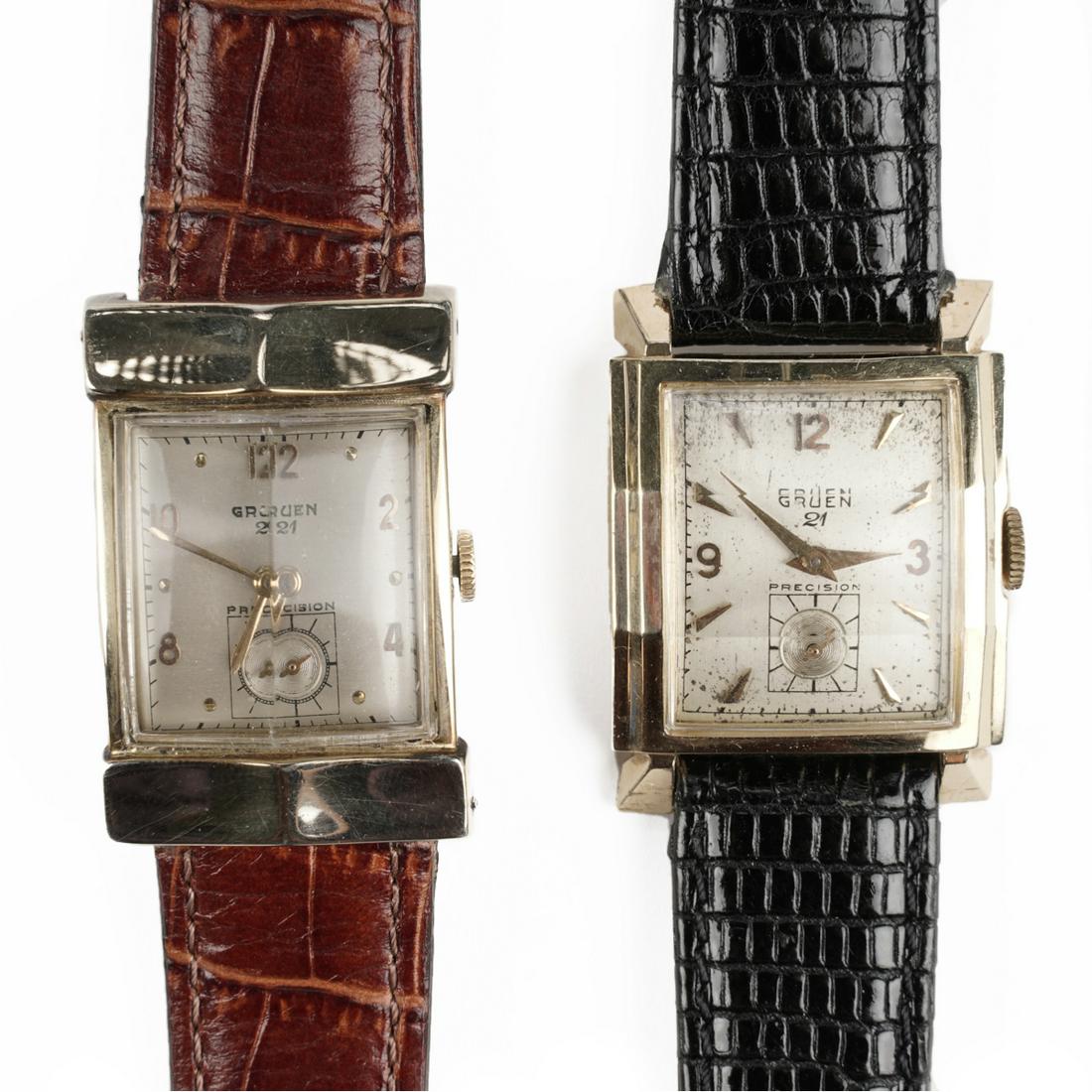 Grp: Vintage Gruen Precision Manual Wrist Watches: Gruen, United States. Group of two mid-twentieth century Gruen Precision 21 jewel watches on leather straps. The watch with the black leather strap has a 14 karat yellow gold case that is rectangular