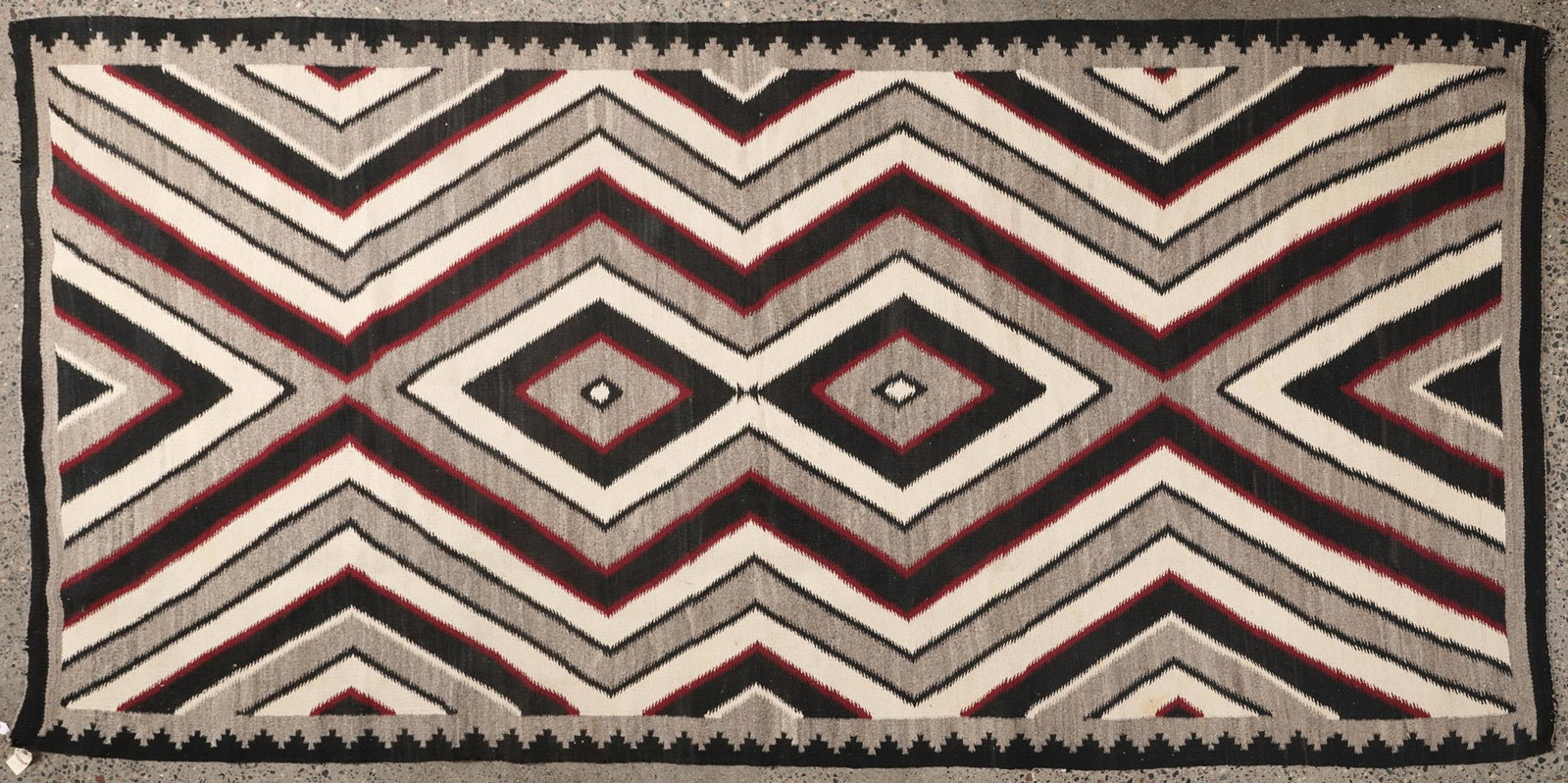 Navajo Blanket Double Medicine Man's Eye 5' x 11': Large and impressive Native American Navajo Double Medicine Man's Eye blanket. Woven in diamond patterns in black, grey, white and red, ca. 1950. Height: 5 ft 5 in x width: 11 ft 8 in.