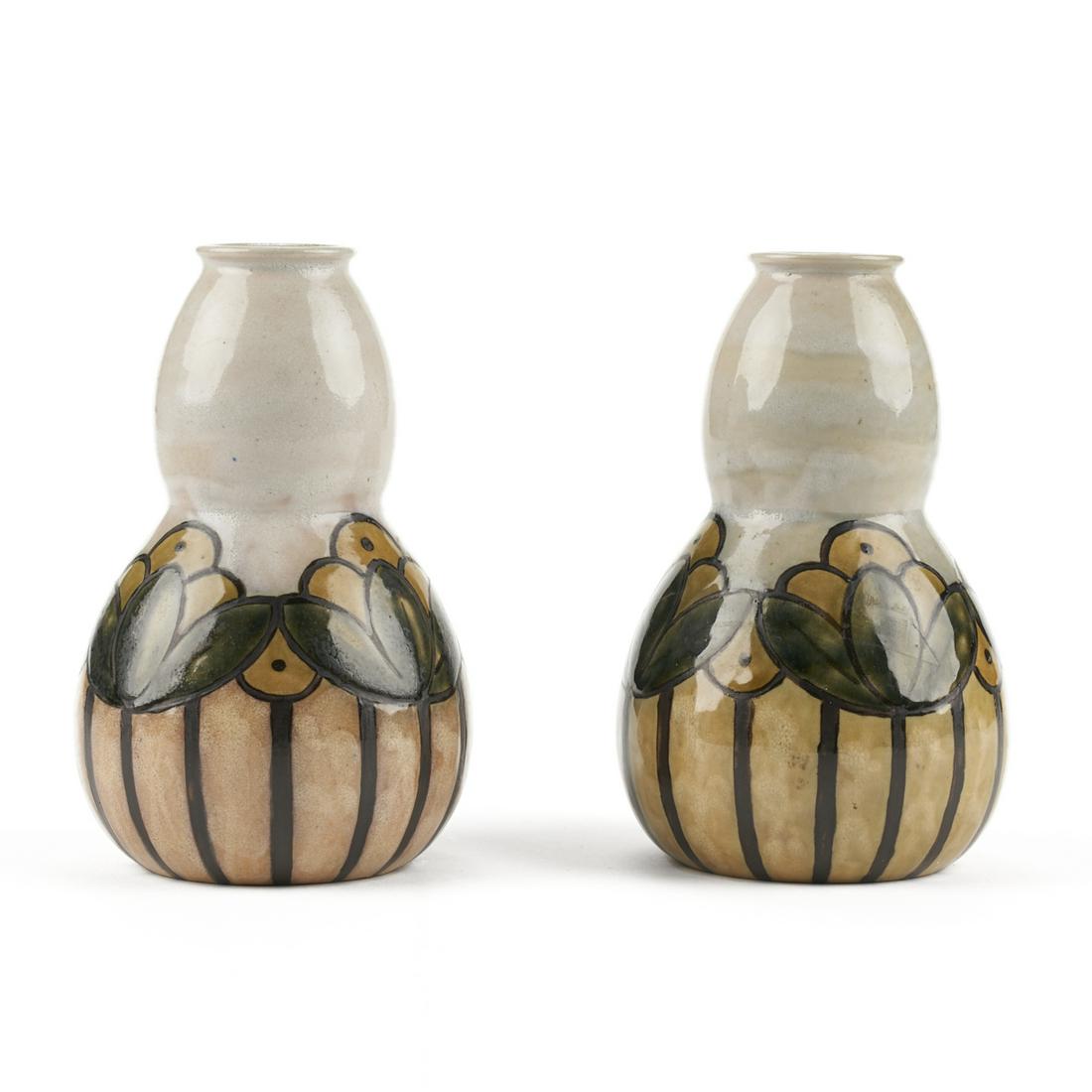 Pair of Royal Doulton Arts & Crafts Newcomb Style: Royal Doulton, Stoke-on-Trent, England. Pair of early 20th century Arts & Crafts pottery vases, decorated with a floral design similar to early Newcomb pottery. Impressed Royal Doulton mark with crown