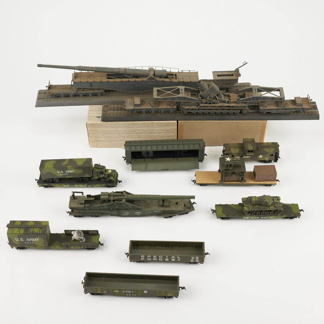 Grp: Military Trains US & German HO Scale: Group of eleven late 20th c. military inspired cars for HO scale model trains, including a Tyco Special Forces car, a Tyco wooden flatbed car with two wooded crates and crate loader. There are five ca