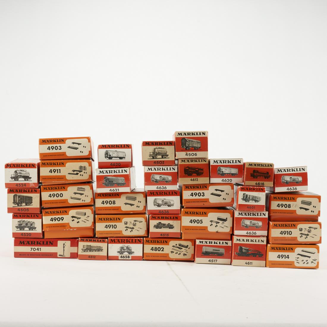 Grp: 33 Marklin Scale Model Train Rail Cars: Marklin, Germany. Group of 33 scale train rail cars, including one model 4524 Esso tank wagon, one model 4505 closed goods car, one model 4520 Bayer container car, one model 7041 push off signal, two