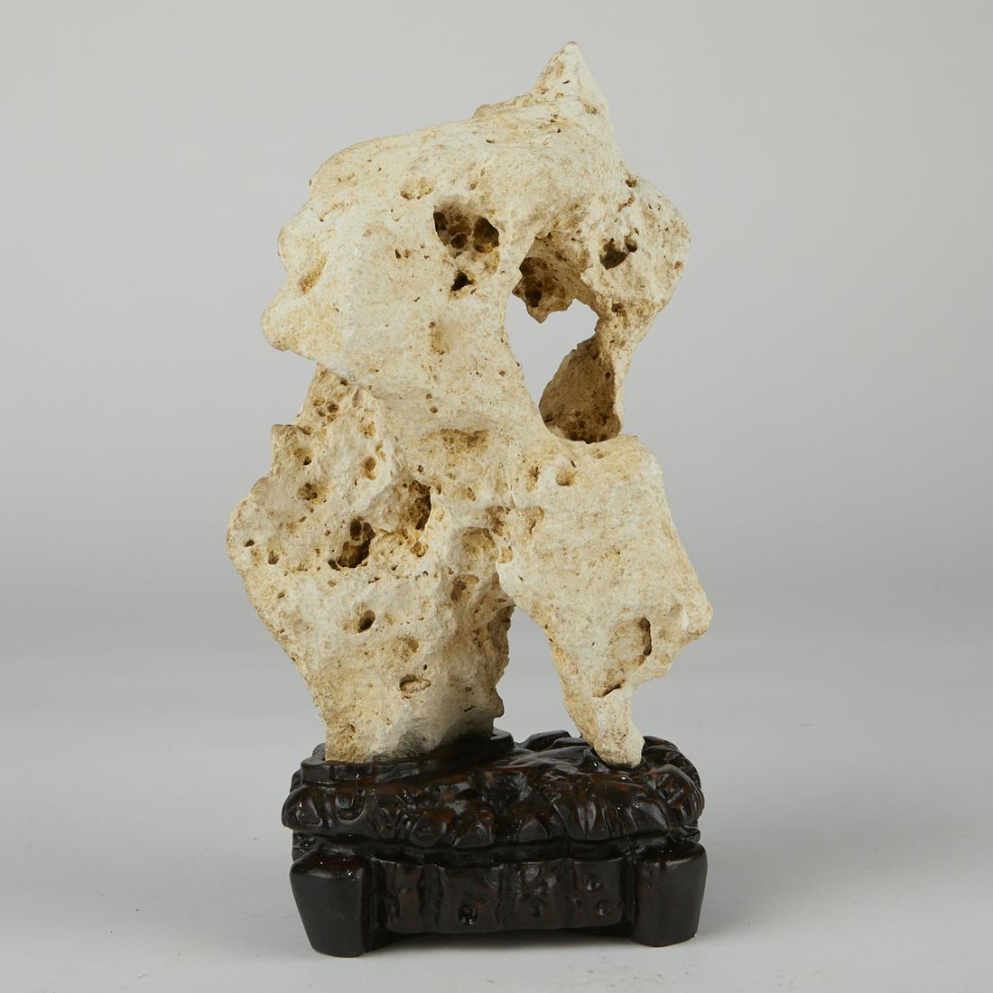 Chinese Gongshi Scholar's Rock 10": Chinese gongshi scholar's rock, a porous stone, set on a carved wooden stand. (Scholar's Rock) Height: 10 in x width: 6 1/2 in x depth: 5 in. (Stand) Height: 2 1/2 in x width: 5 3/8 in x depth: 4 1/8