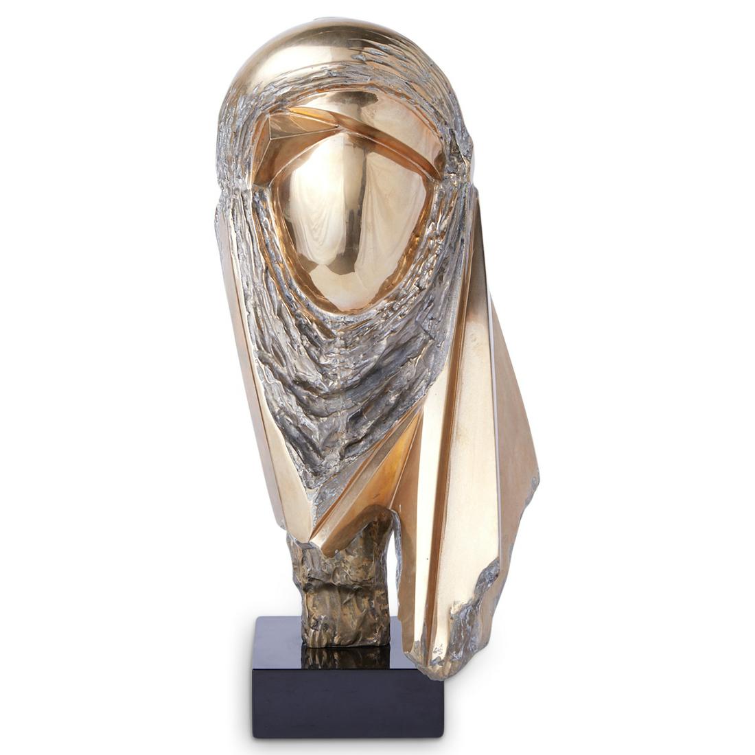 Antonio Kieff Bronze Sculpture: Antonio Grediaga Kieff (Canadian/Spanish, b. 1936). Bronze sculpture depicting an abstracted representation of a face with an enveloped hammered and textured veil surrounding the center. Mounted on a 