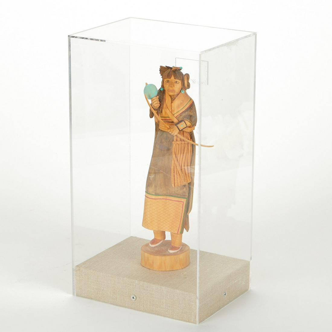 Katsina Doll by Kerry David: Kerry Lyle David (American (Hopi), 20th century). Finely carved cottonwood root Katsina (kachina) doll in an acrylic case. Doll depicts a figure with painted turquoise adornments. With a guarantee of 