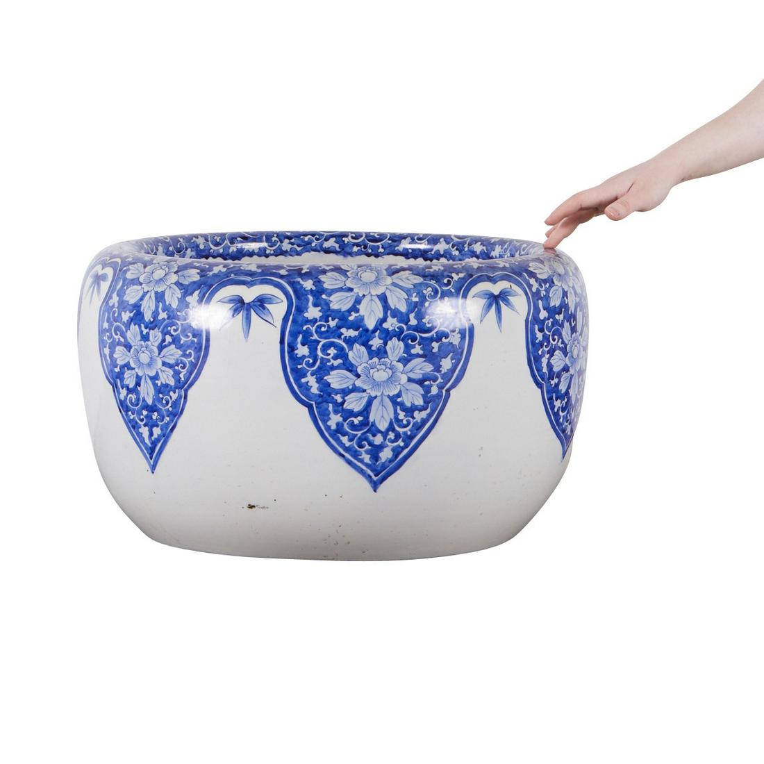 Large Meiji Japanese Arita Porcelain Hibachi: Japanese Meiji period large Arita porcelain hibachi. With blue and white decoration of scrolling and floral motifs. Height: 12 1/2 in x diameter: 21 1/2 in.