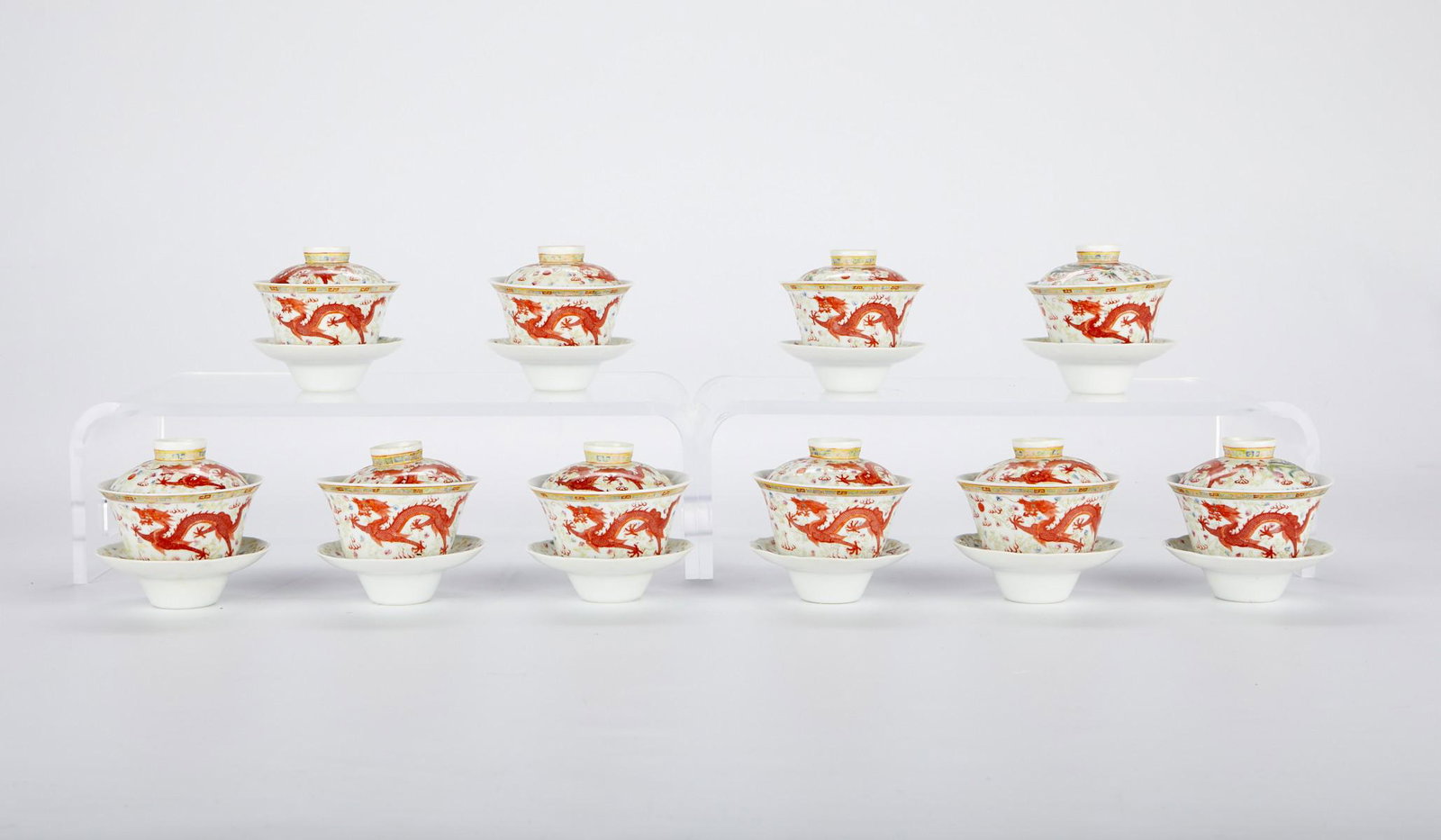 Grp: 10 Chinese Porcelain Lidded Bowls: Set of ten Chinese porcelain lidded bowls with saucers. Decorated with dragons and phoenixes and famille rose enamels. Each with a six character mark along the underside. Bowls (each); height: 2 1/4 i