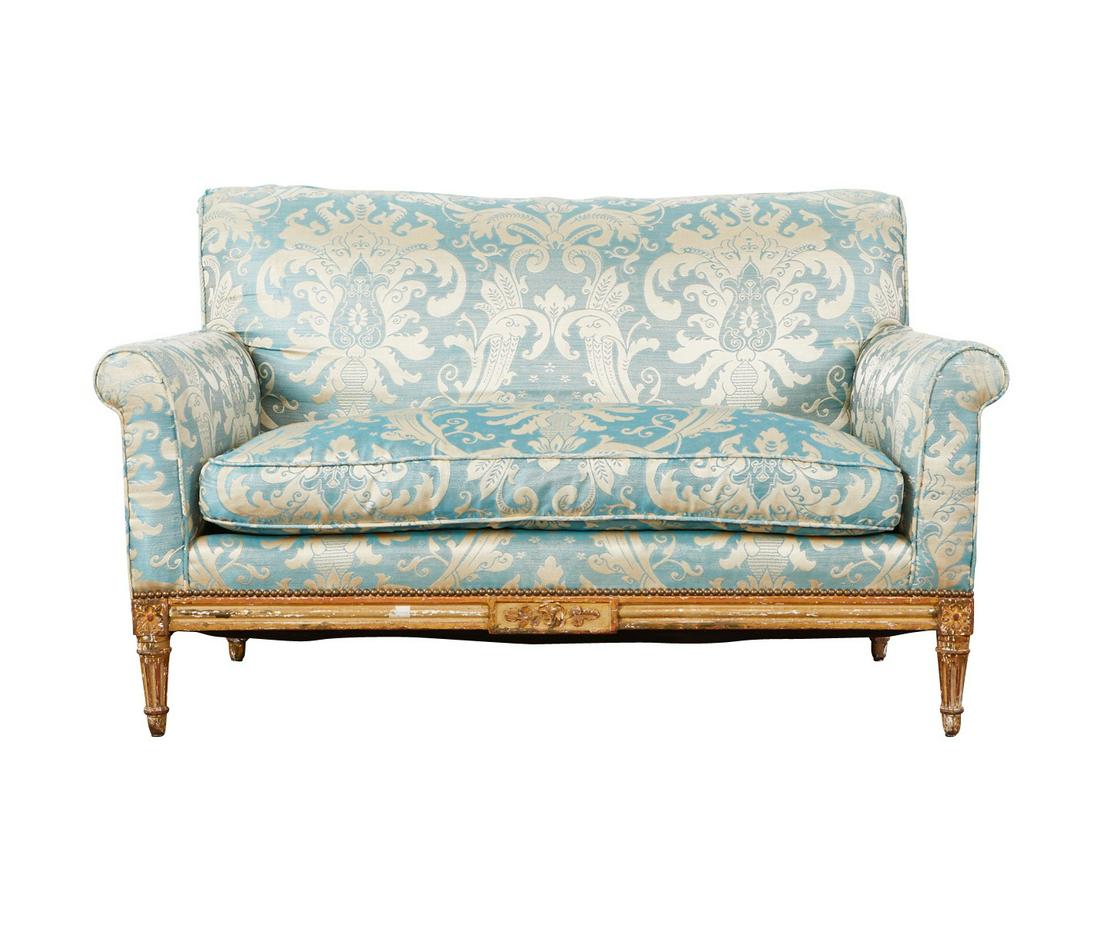 French Upholstered Giltwood Loveseat or Settee: French loveseat or settee, with a giltwood base and fluted legs. With teal and gold upholstery with a scrolling design. Height: 31 1/2 in x width: 53 in x depth: 26 in.