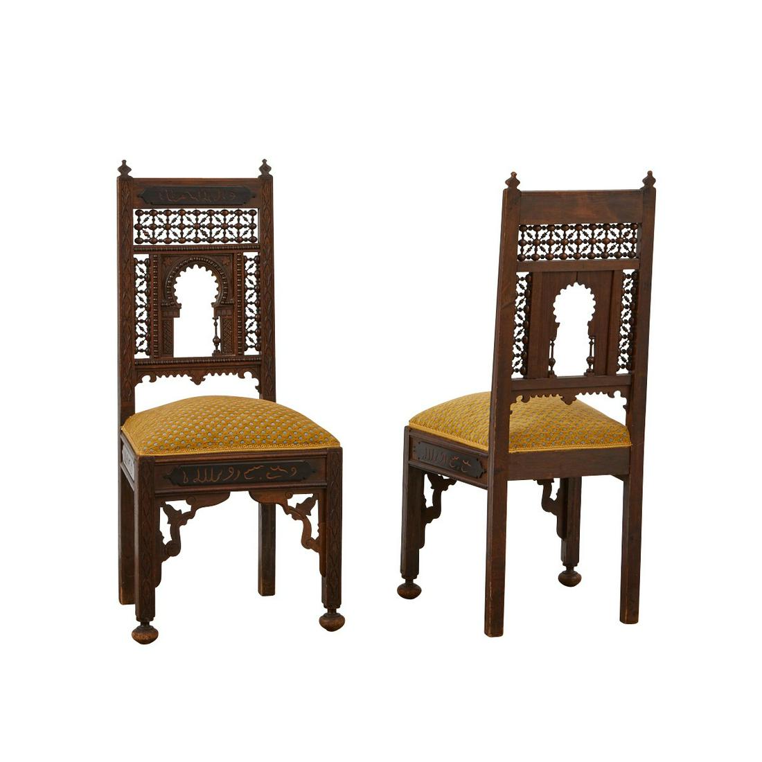 Pair of Syrian Carved Wooden Chairs: Pair of Syrian carved wood side chairs with mashrabiya style latticework backs. The back and skirting are incised with Arabic inscriptions. With upholstered seats. Keywords: Levantine, Persian, Morocc