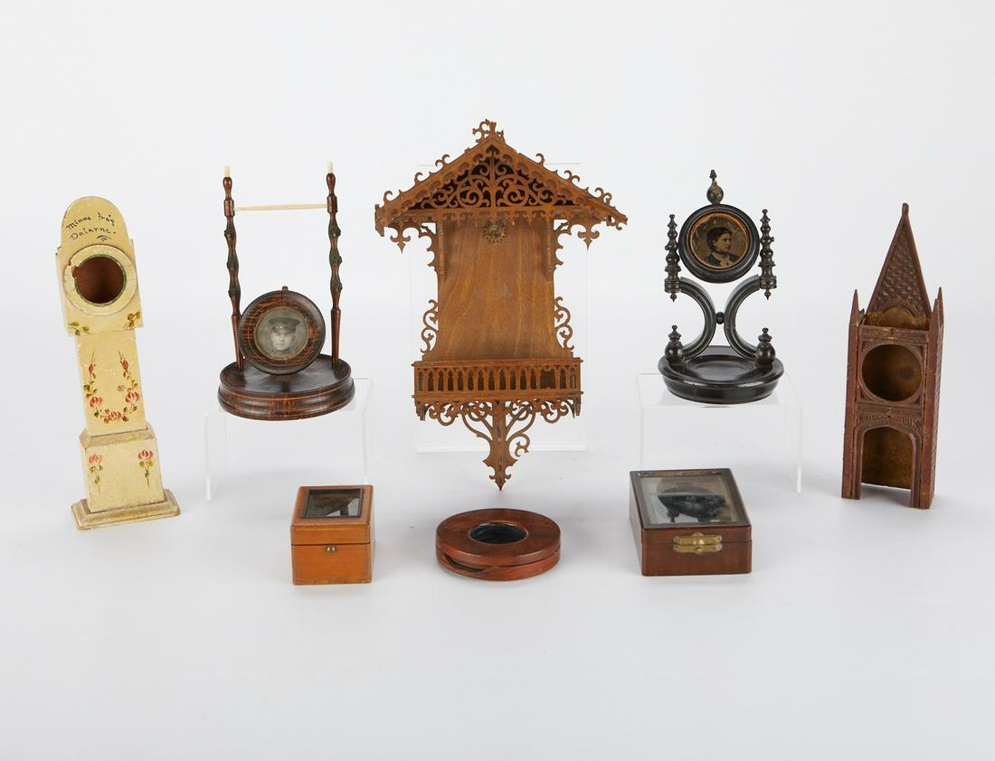8 Decorative Watch Displays and Decorations: Group of eight decorative wooden objects including two picture frames, two displays for clocks or watches in the form of a clocktower and a grandfather clock, three cases for display of watches, and o