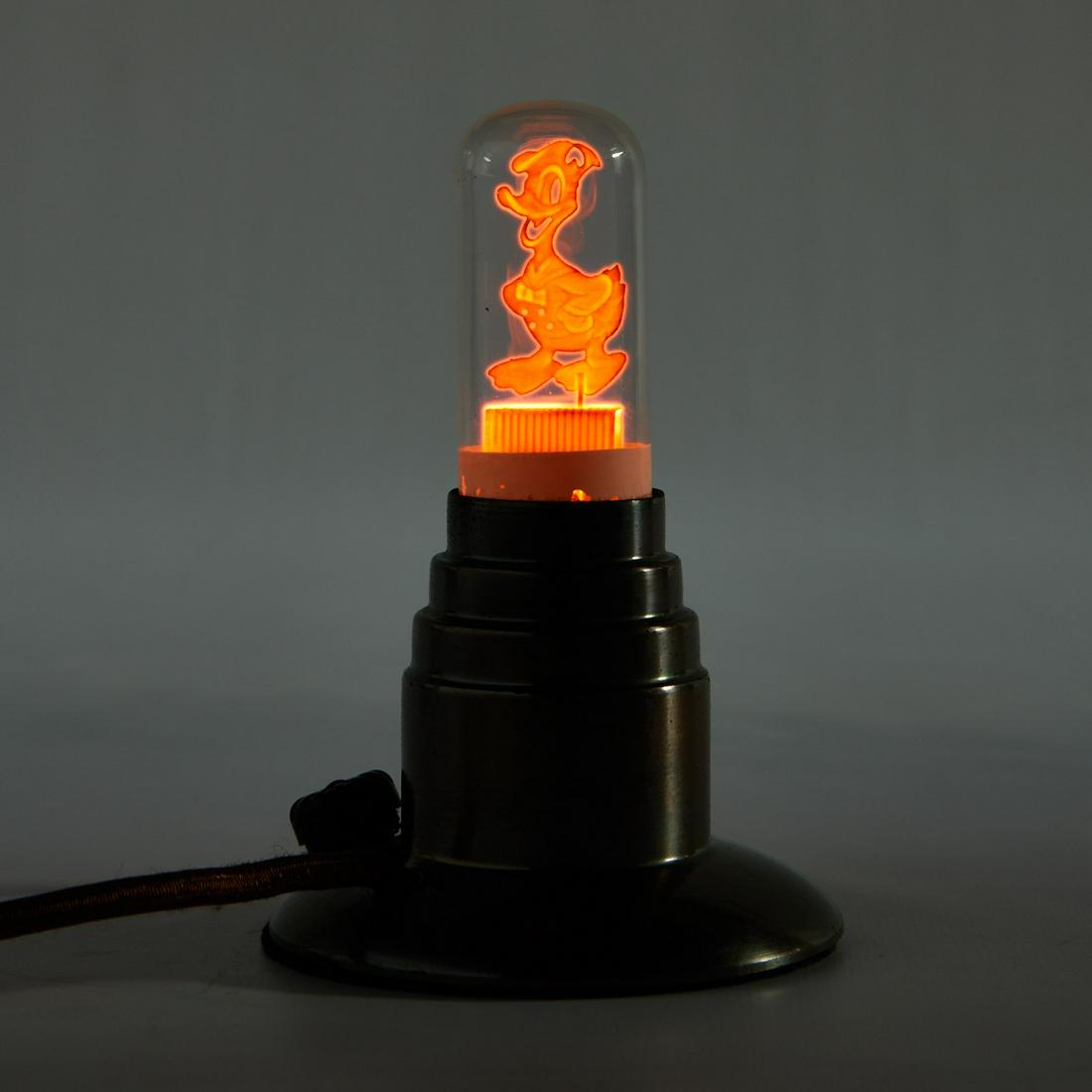 Aerolux Filament Bulb Disney Donald Duck: Aerolux, United States. Die-cut metal filament lightbulb in the form of Disney's Donald Duck, ca. 1930s. The bulb rests within a metal housing in the form of a candlestick with a Catalin or Bakelite p