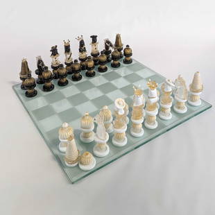 Italian Murano Glass Chess Set w/ Gold: Italian Venetian Murano glass chess set infused with gold leaf. One half of the set in white and the other half of the set in black. With a glass chess board.Height ranges from 4 in to 7 in; diameter: