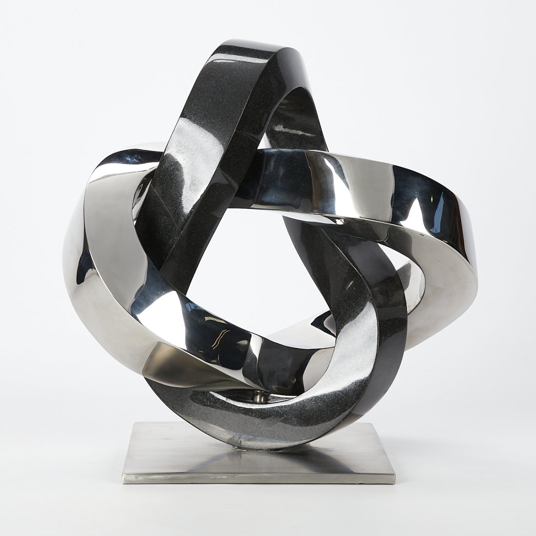 Wangstone Abstract Stainless Steel Sculpture: Wangstone Metal Sculpture Co., Ltd., China. Stainless steel modern abstract sculpture. With the original shipping box. Height: 17 in x width: 15 1/2 in x depth: 10 in.