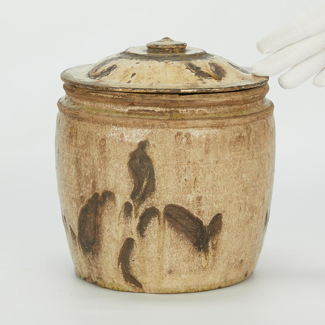Vietnamese Ly Dynasty Jar w/ Iron Oxide Decor: Thanh Hoa Jar, Vietnam, Ly Dynasty, ca. 12th century. A thin celadon glaze over a buff body with incised floral decoration highlighted with a brown iron oxide glaze in the style of Chinese Cizhou ware