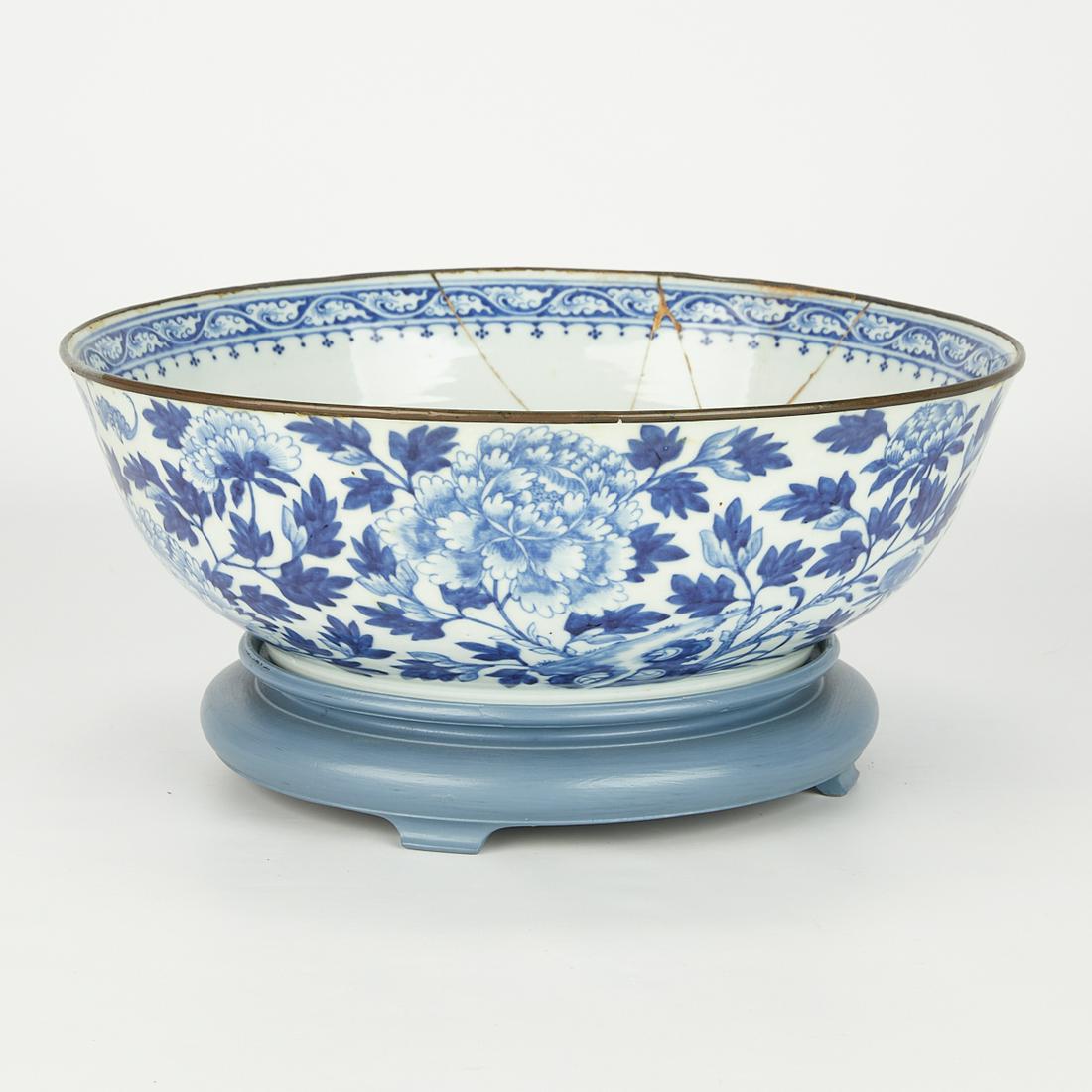 Chinese Porcelain Punch Bowl w/ Kintsugi Repair: Large 19th century Chinese blue and white porcelain punch bowl. Decorated with peonies and profuse foliage throughout and a painted cafe au lait border. With a large Kintsugi gold repair along the sid