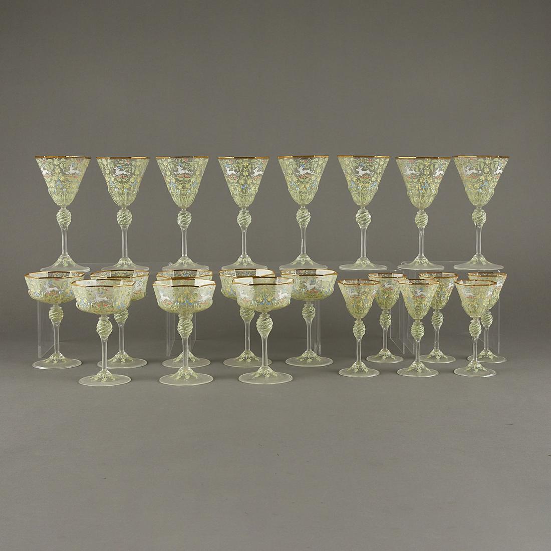 Set 22 Venetian Glass Octagonal Goblets: Group of hand-blown Venetian Murano Glass octagonal goblets. Each painted with floral and foliate motifs throughout with leaping animals. With gilt rims. The set includes: eight wine glasses, eight ch