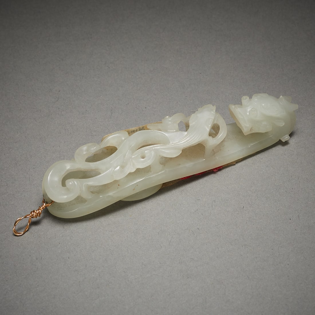 Chinese Pale Jade Dragon Belt Hook: Chinese pale jade belt hook carving in the form of a dragon. With a sticker from Ming's, a Minneapolis Chinese antique shop that closed in the 1980s.Provenance: Private Minneapolis Collection - collec