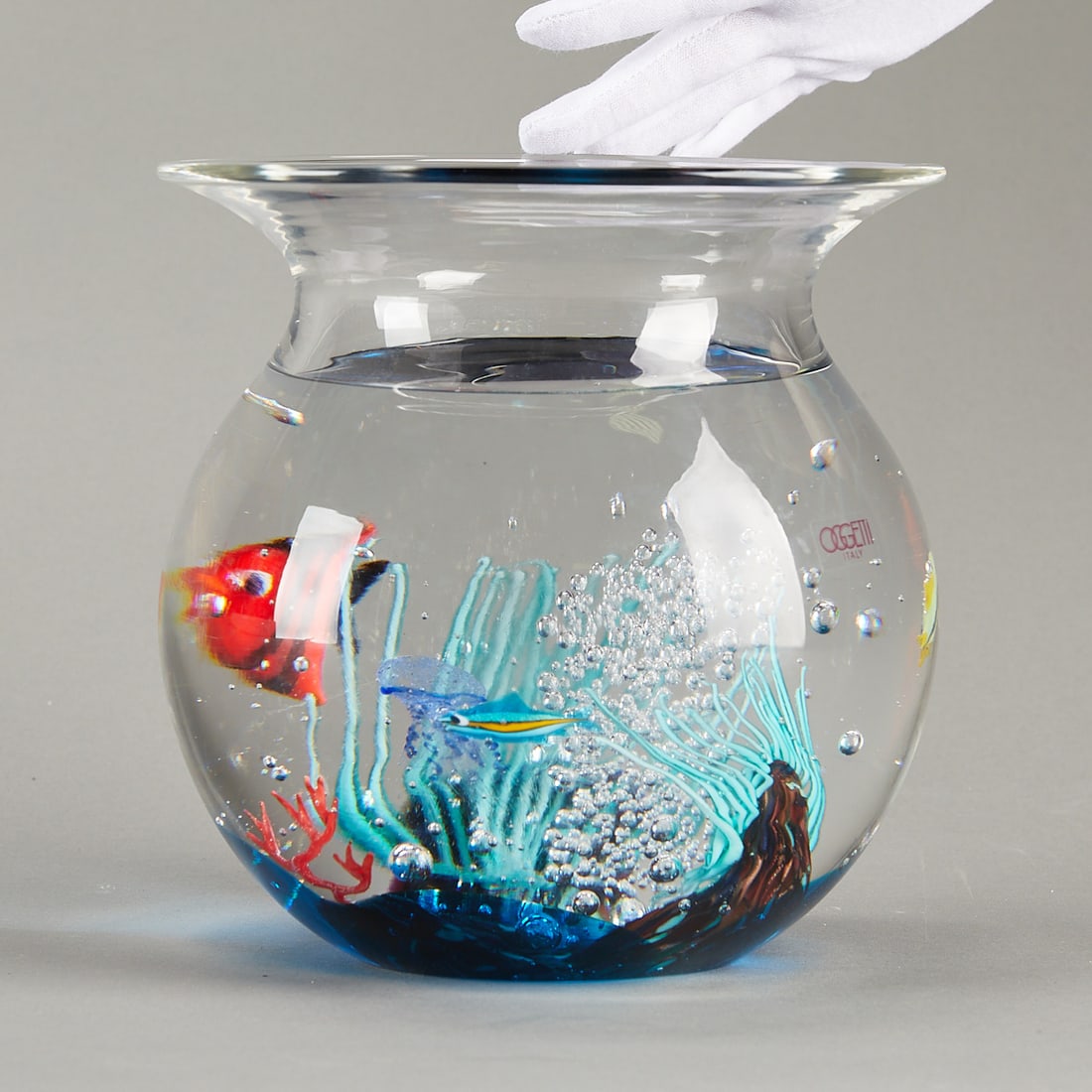 Elio Raffaeli for Oggetti Italian Glass Fishbowl: Elio Raffaeli (Italian, b. 1936) for Oggetti, Murano, Italy. Venetian blown glass fishbowl. Signed along the underside. With the original Oggetti sticker.Height: 8 in x diameter: 8 in.