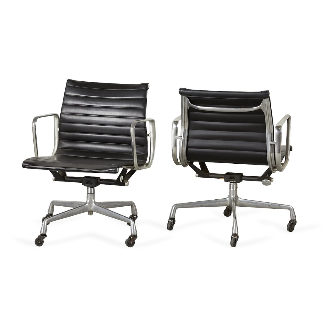 Pair of Aluminum Group Eames Chairs: Charles Eames (American, 1907-1978) and Ray Eames (American, 1912-1988) for Herman Miller, United States. Pair Aluminum Group office chairs designed in 1958. Cast aluminum, leather upholstery, and rub