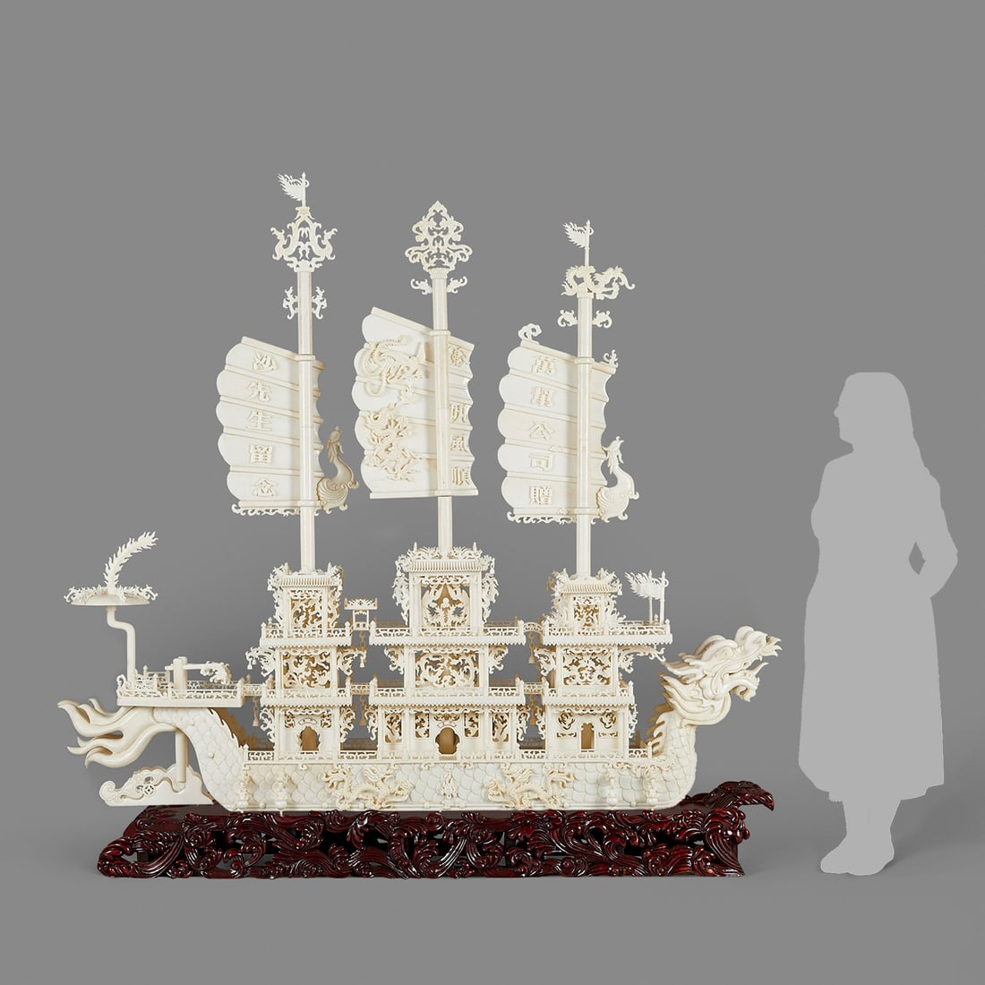 Massive Chinese Hardstone Dragon Ship: Massive Chinese carved hardstone dragon ship. Decorated throughout with dragon and phoenix motifs. With three large sails, chains, bells, a chandelier, rudders, and anchors. With a large wooden stand.