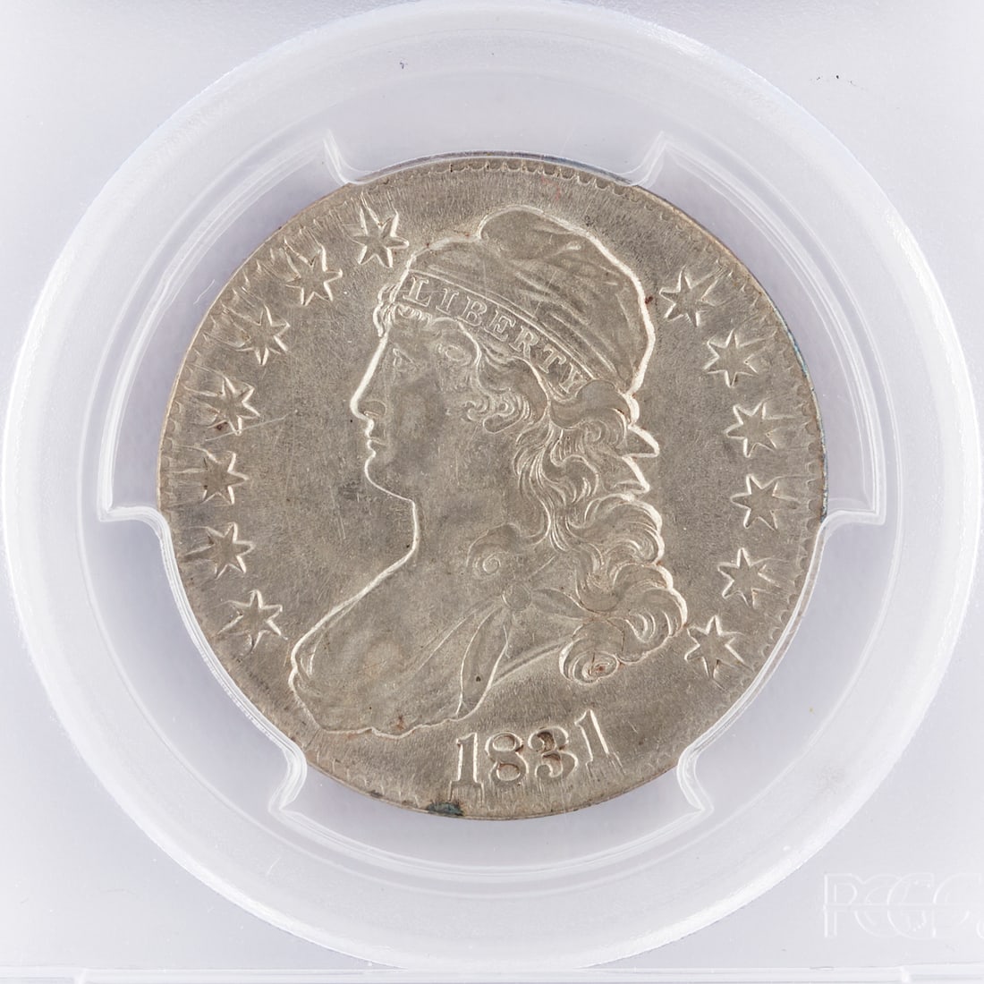 1831 50 Cent Silver Capped Bust Coin: 1831 silver 50 cent half dollar coin. One side depicting a capped bust and the other the seal of the United States. Designed by John Reich. PCGS genuine not gradable.Diameter: 32.50 mm. Weight (approx