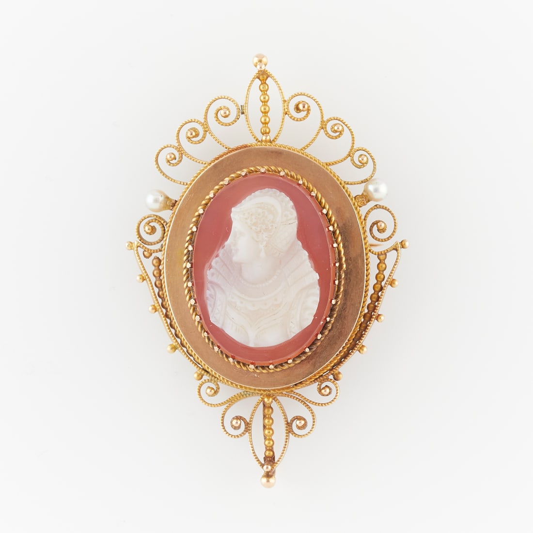 Mary Queen of Scots Cameo Brooch: Mary, Queen of Scots hardstone cameo brooch, set in an ornate filigree gold plated frame. Metal unmarked, with C clasp and hidden bale.Height: 53.54 mm x width: 35.11 mm. Gross weight: 10.9 grams.