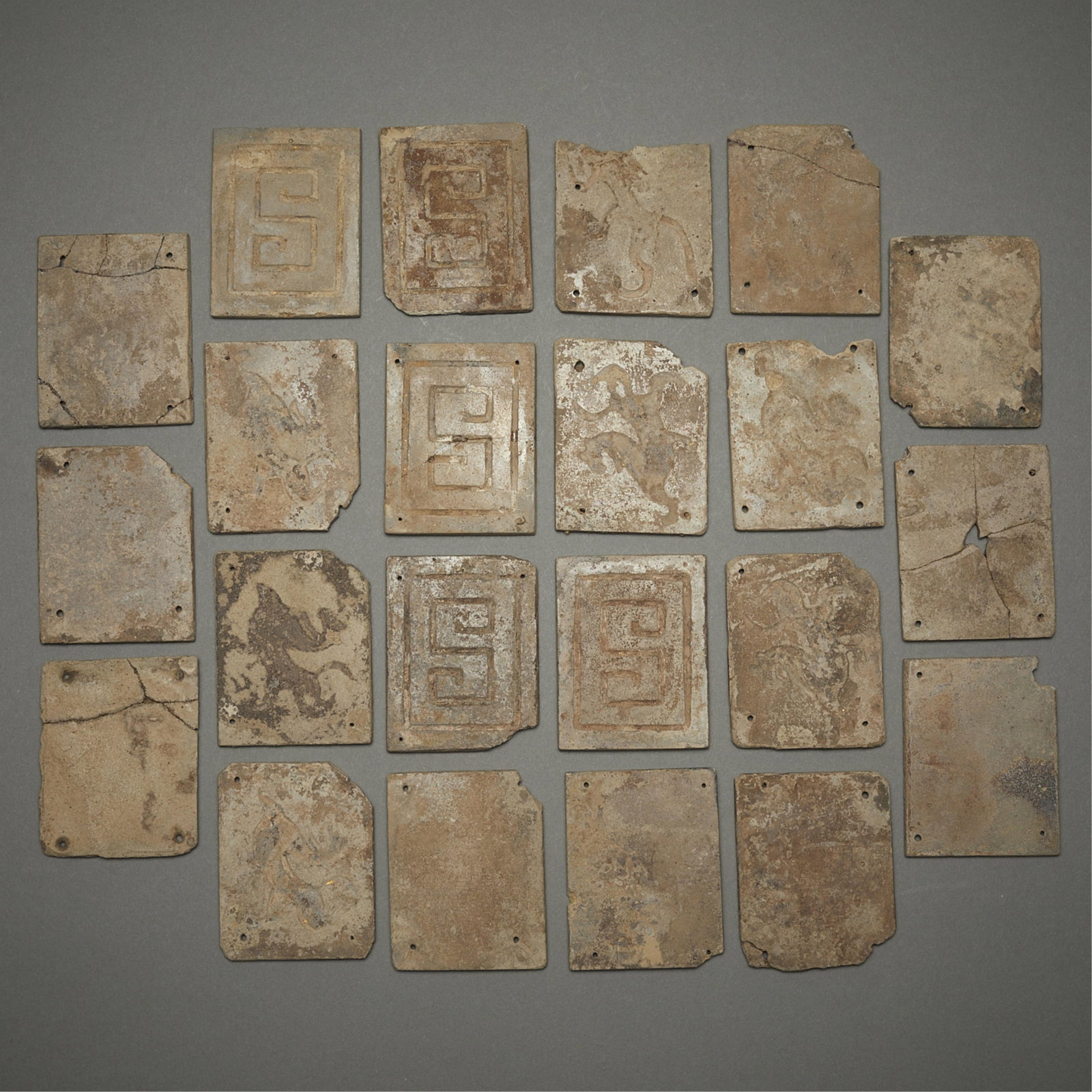 22 Chinese Han Calcified Plaques: Group of 22 Chinese Han dynasty calcified plaques. Several with incised S-form decoration. Others with central designs of striding dragons. Provenance: Robert Ellsworth, New York; Private Minnesota Co