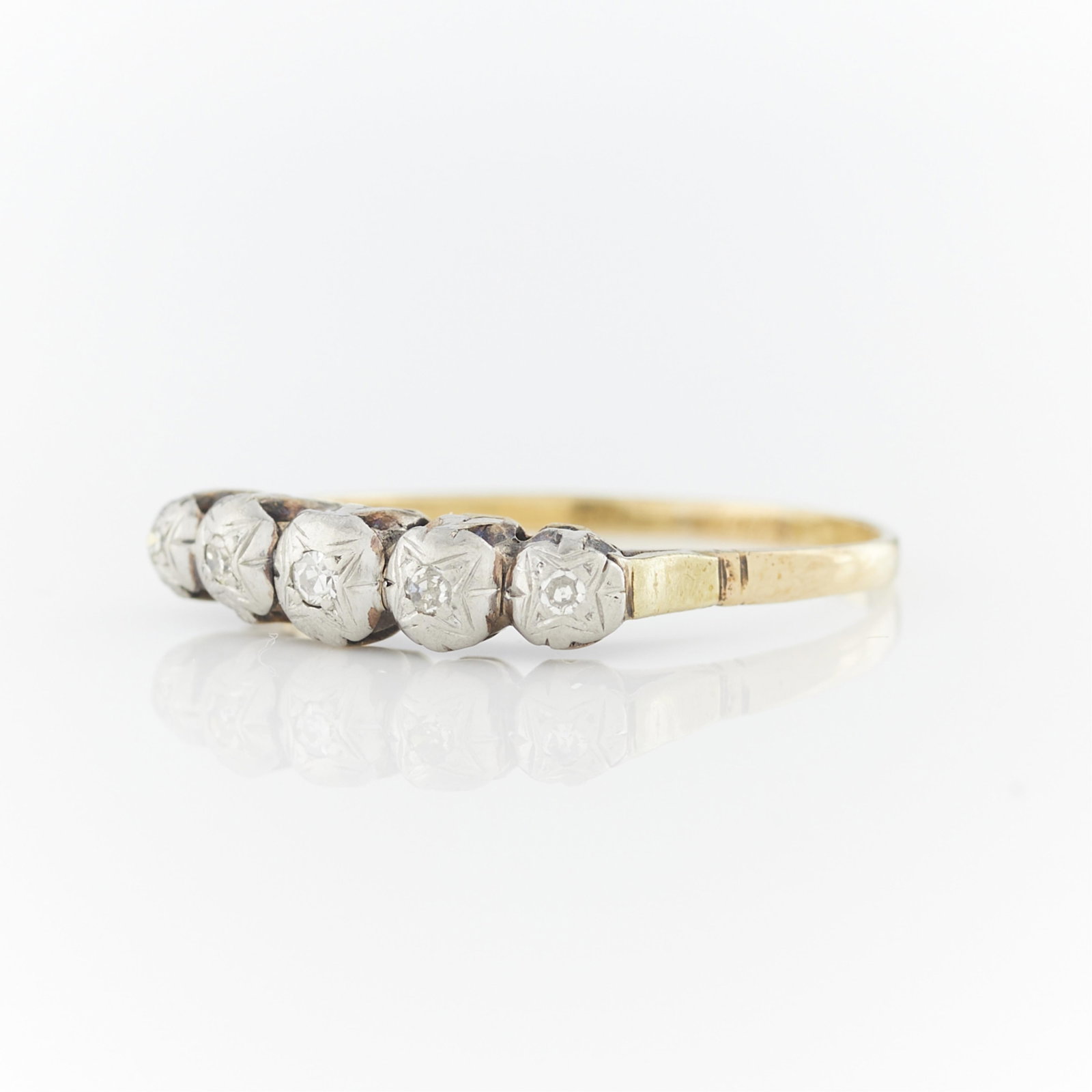 18k Gold & Diamond Ring: 18k yellow and white gold ring set with five single cut diamonds in white gold. The shank and gallery in yellow gold. Unmarked, tested 18k. Circa 1920s. Ring size: US 10.25. Gross weight: 2.3 g.