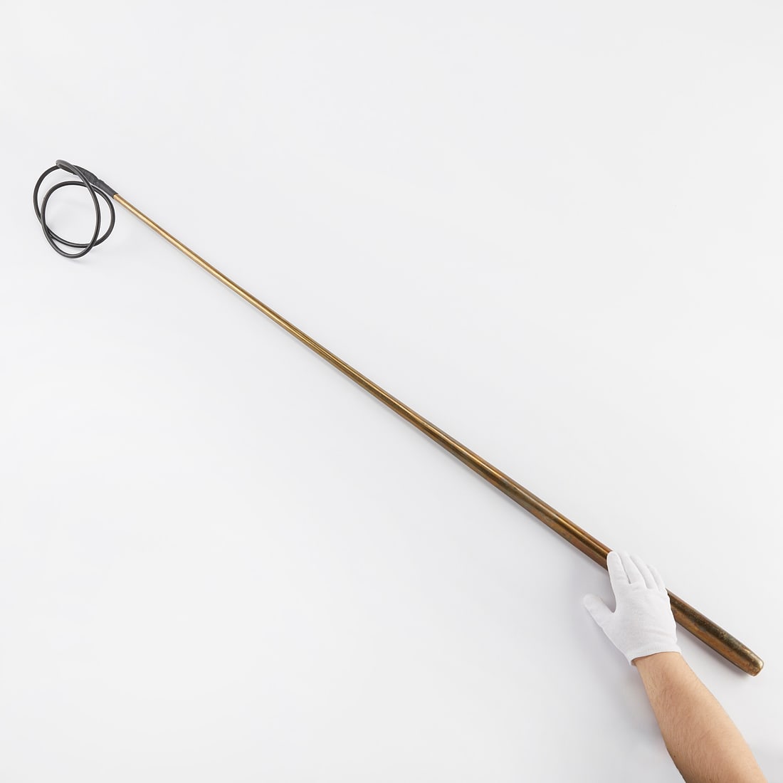 Jay Heikes "Stranglehold" Bronze Sculpture: Jay Heikes (American, b. 1975). Large sculpture titled "Stranglehold" in the form of a gradually decreasing rod topped by a loop, 2006. Bronze, copper, and rubber.Height: 59 in x width: 6 1/