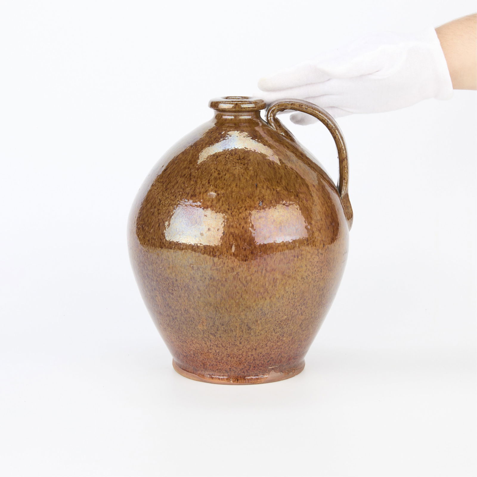 Early 19th c. New England Redware Ceramic Jug: Early 19th century ceramic pottery jug, possibly from Bristol County, Massachusetts, circa 1810-1830. Redware with a dark alkaline glaze. Of a bulbous, highly ovoid form with an applied arch handle ex