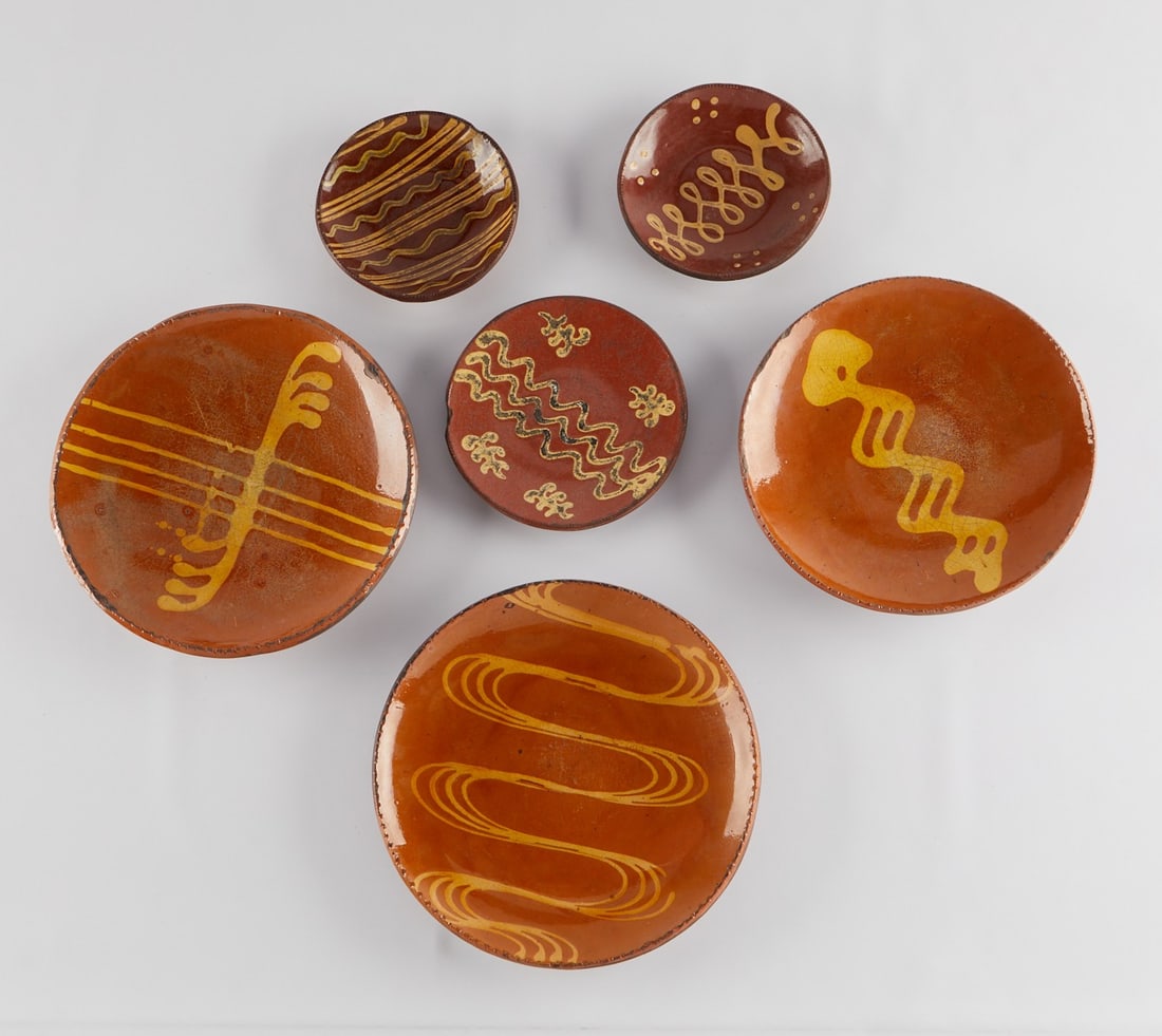 6 Modern Redware Plates Woods and Huntley: Group of six redware lead glazed and slip decorated stoneware pottery ceramic plates and chargers. The three larger charges each with an incised signature along the back by Christopher Woods (American