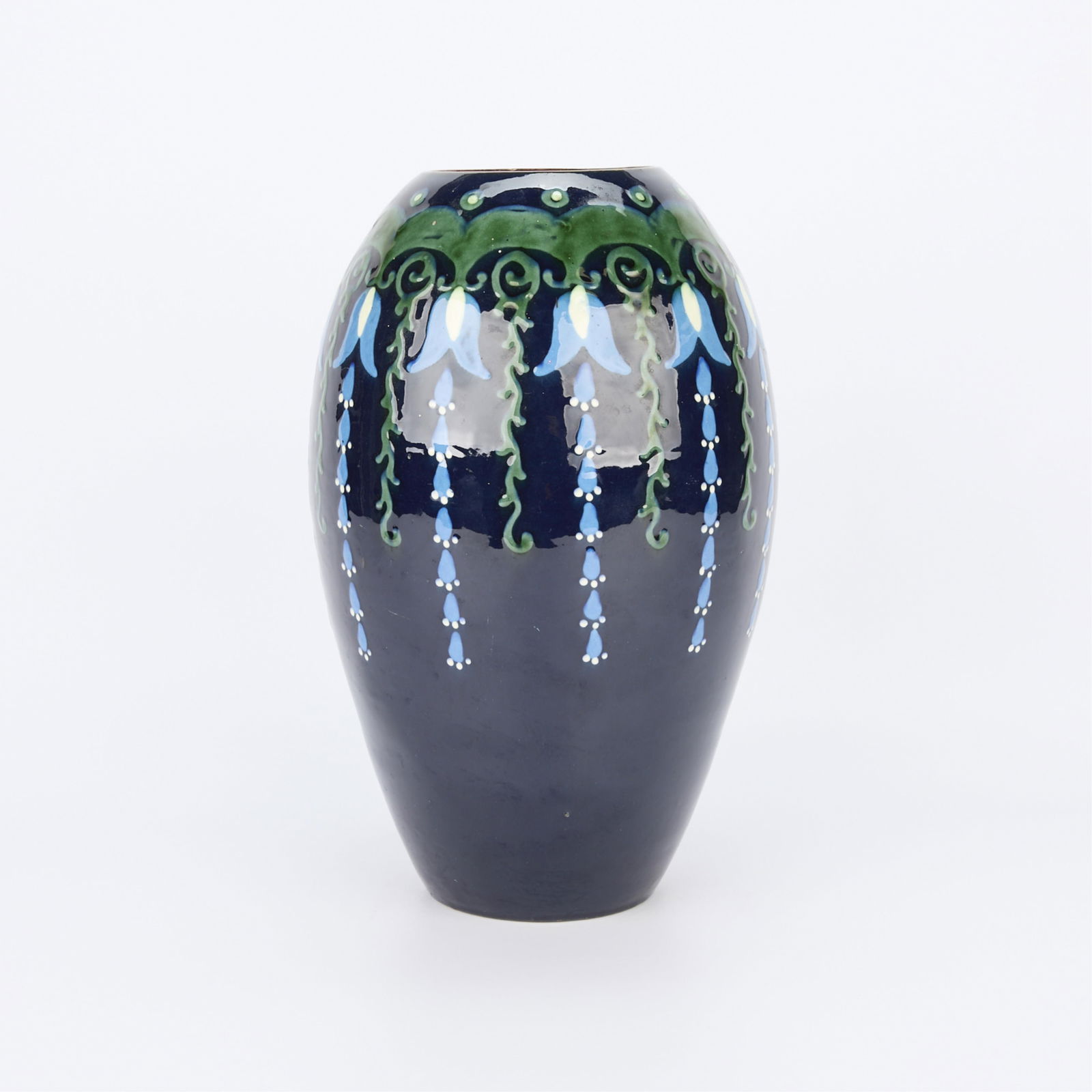 Max Laeuger for Karlsruhe Majolika-Manufaktur Vase: Attributed to Max Laeuger (German, 1864-1952) for Karlsruhe Majolika-Manufaktur, Germany. Ceramic vase with profuse blue floral and foliate motifs cascading along the exterior, early 20th century. Imp