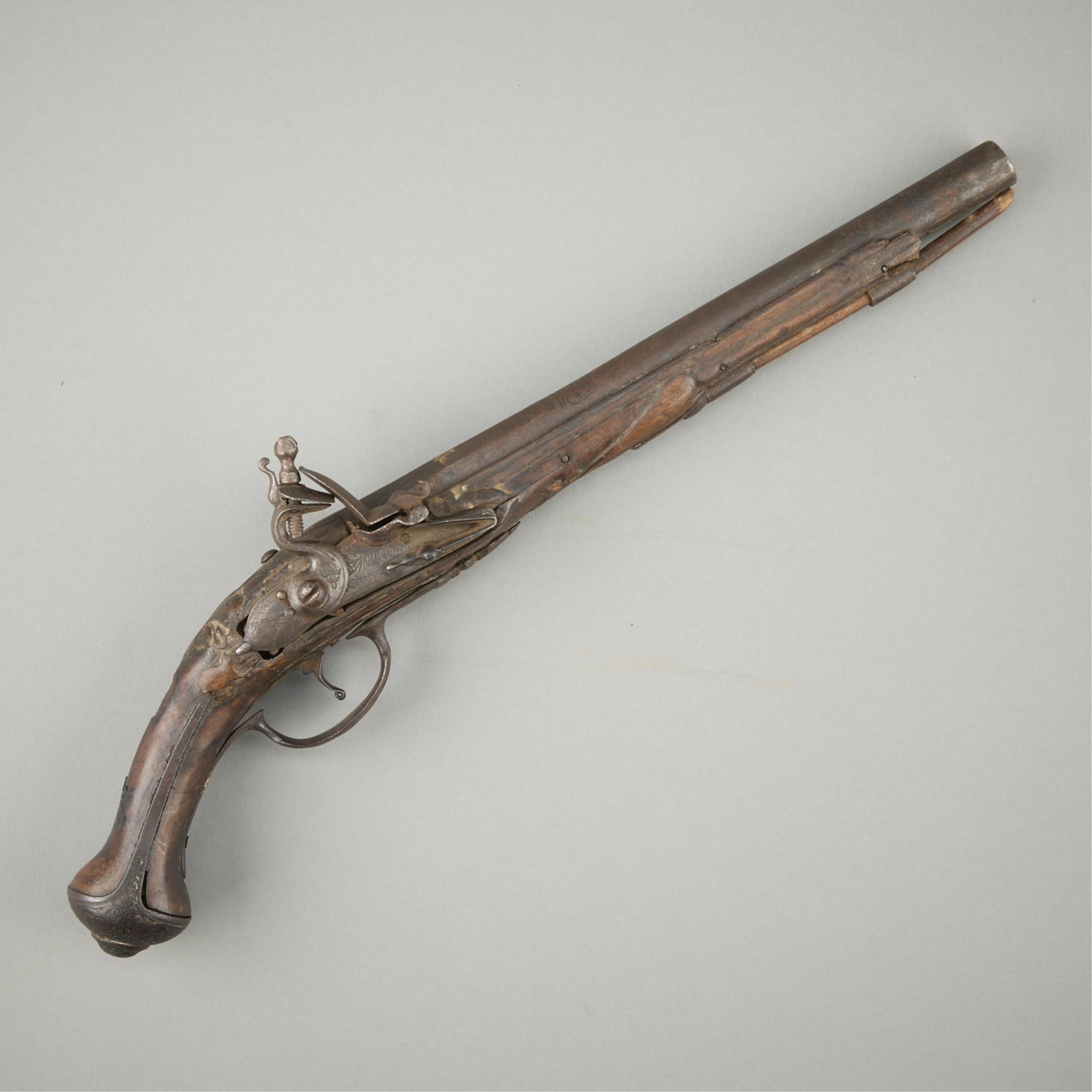19th c. Large Flintlock Cavalry Pistol: Large early 19th century flintlock cavalry pistol, possibly French or British. With an eleven-inch barrel and ornately engraved foliate motifs and scrollwork along the metal components of the stock an