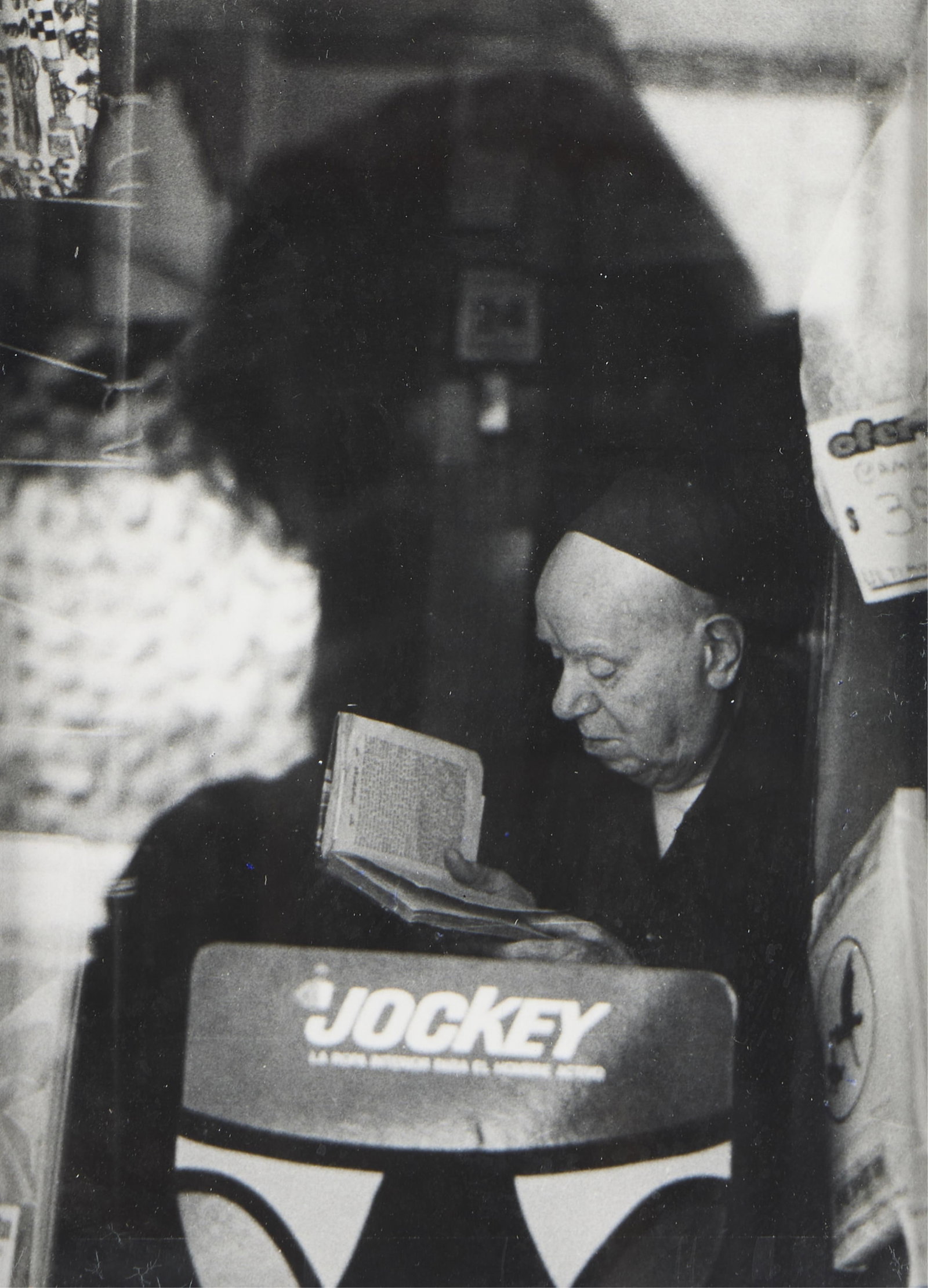 Anatole Saderman GSP Photograph of Man: Anatole Saderman (Russian/Argentine, 1904-1993). Gelatin silver print photograph depicting an elderly man reading a book as seen through a window. Sight; height: 9 3/4 in x width: 7 in. Framed; height