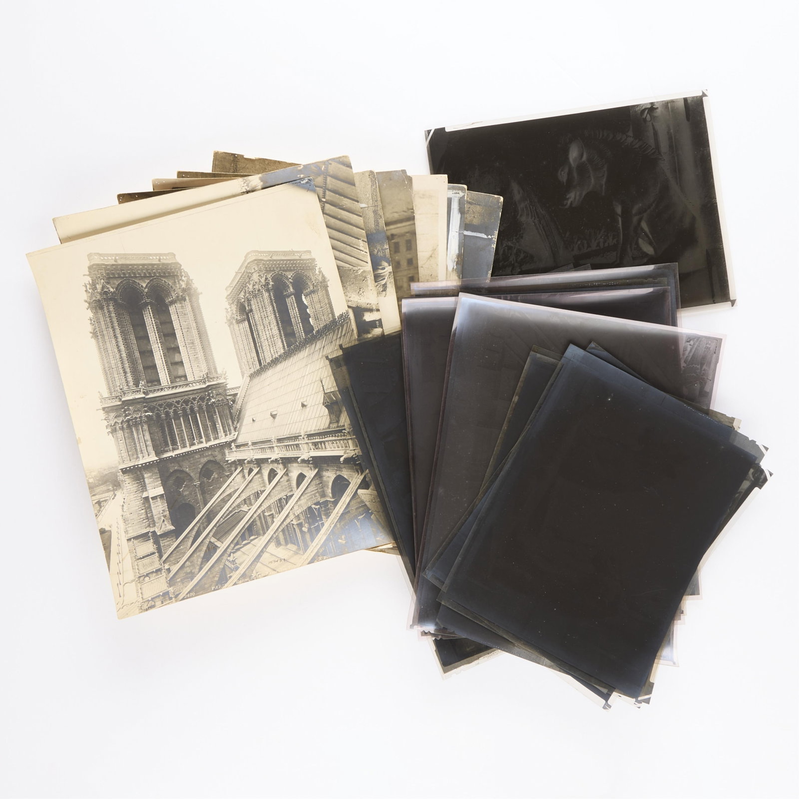 19 Vintage Notre Dame Gargoyle Photos & Negatives: Group of vintage original gelatin silver print photographs and photographic negatives depicting gargoyle statuary on the Notre Dame Cathedral in Paris, France. Including eight photographs and 11 negat