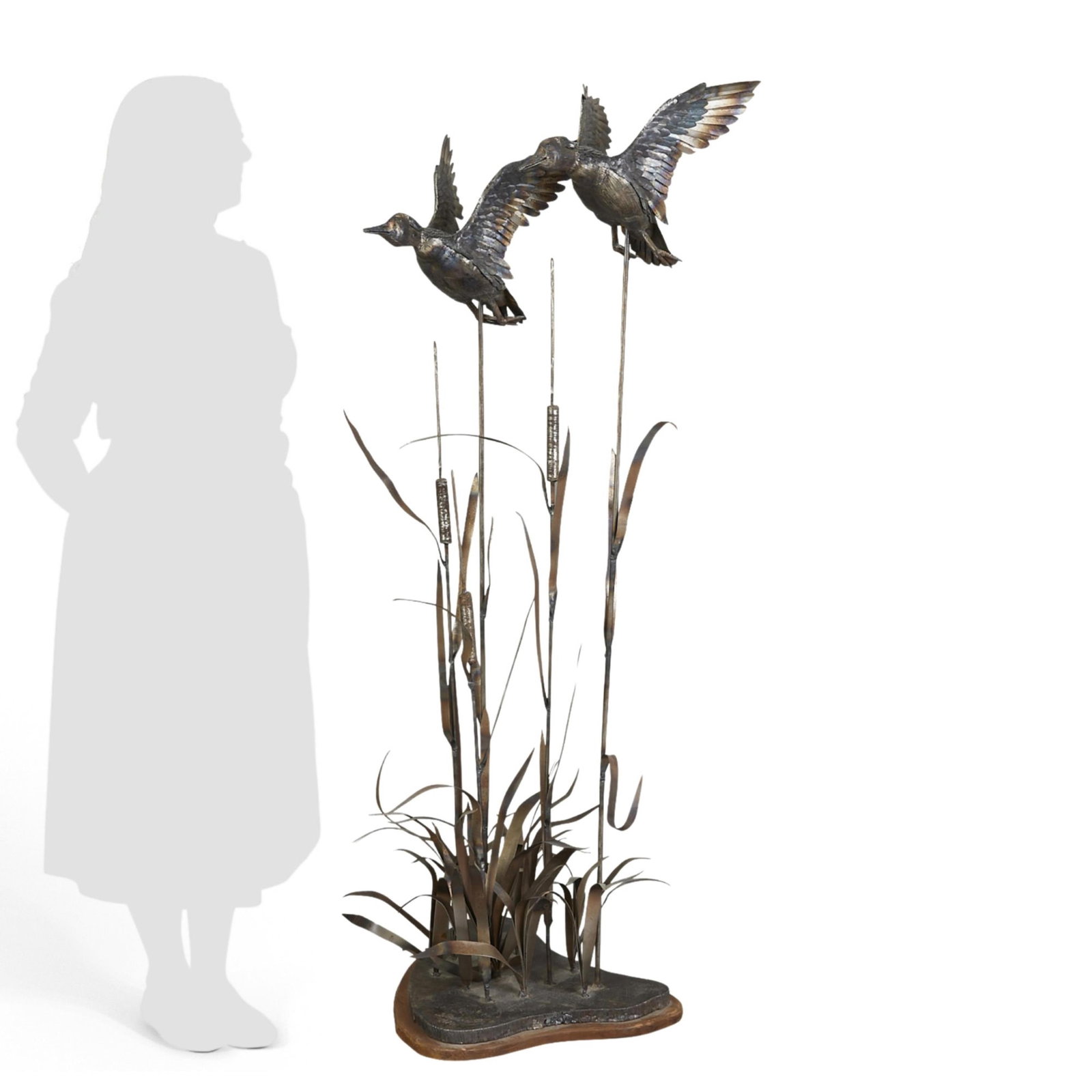 Large Jim Dolan Steel Wood Ducks Sculpture: Jim Dolan (American, b. 1949). Large steel sculpture depicting a pair of ducks flying above cattails, 1976. Signed and dated along the base. Height: 53 in x width: 22 in x depth: 16 in. Weight: 54 lbs