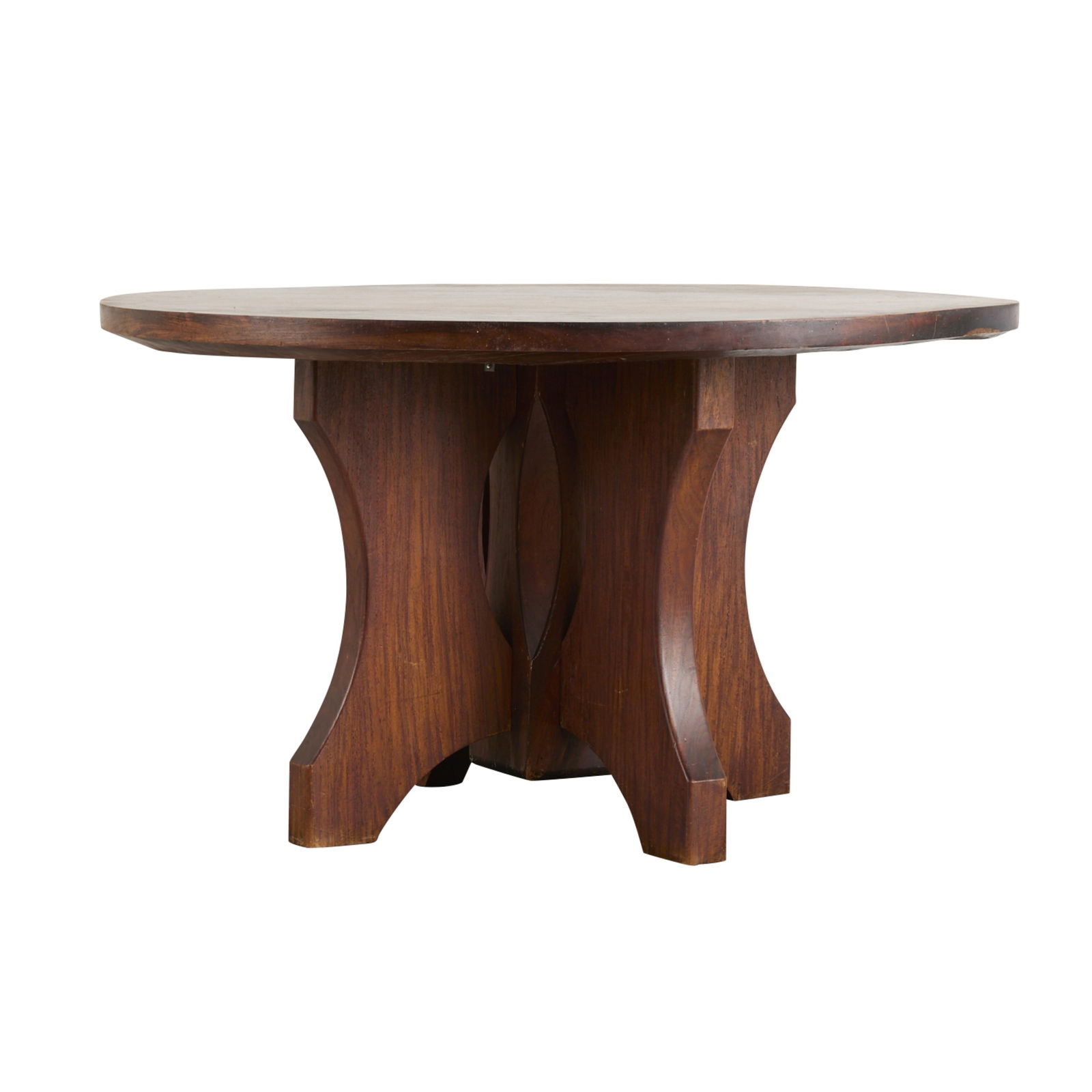 Rosewood or Mahogany Round Pedestal Dining Table: Carved round hardwood pedestal dining table, ca. 1940s. Possibly rosewood or mahogany. The table top is composed of one solid piece of wood; the base consisting of five separate pieces which are fitte