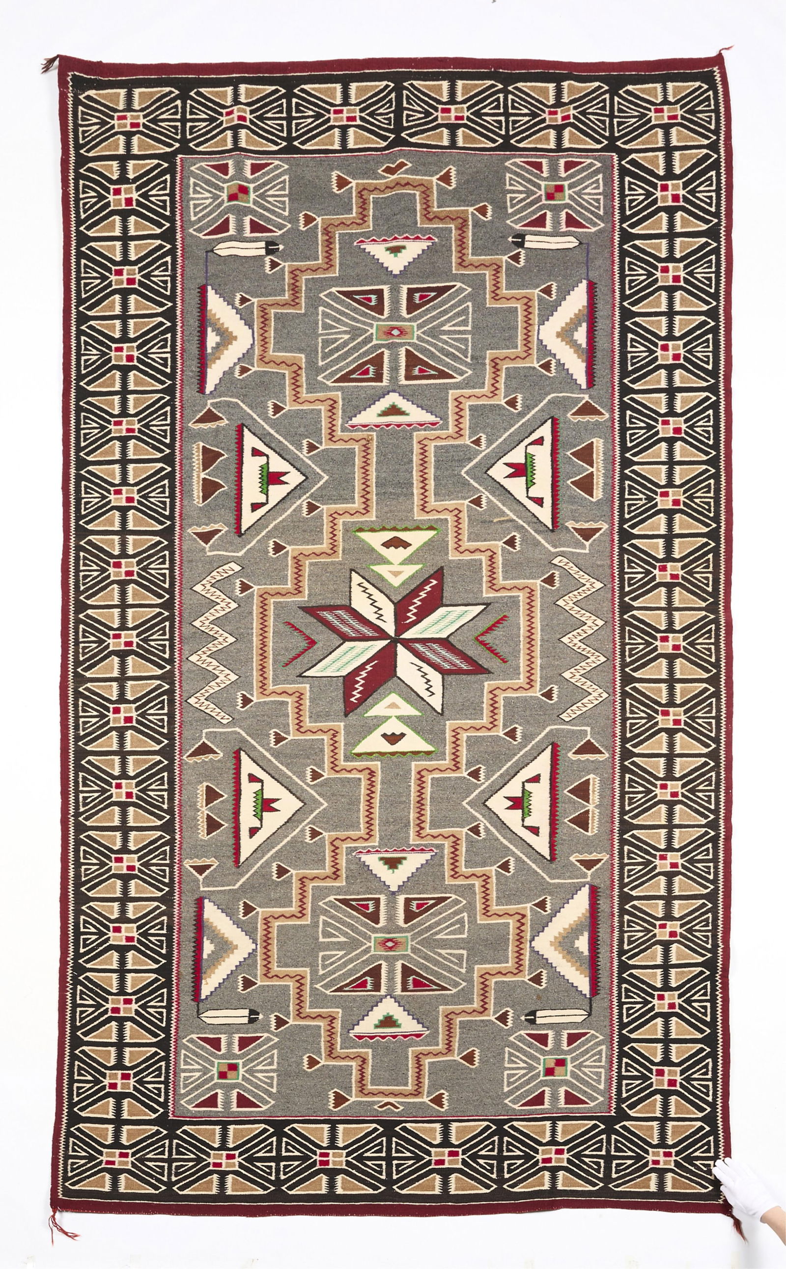 Lrg Navajo Teec Nos Pos Rug 9'7"x5'7": Navajo or Dine wool weaving or wall-hanging rug featuring a Teec Nos Pos pattern, early 20th century. Finely woven and intricately detailed in grey, beige, and red dyed wools; reserved green accents i