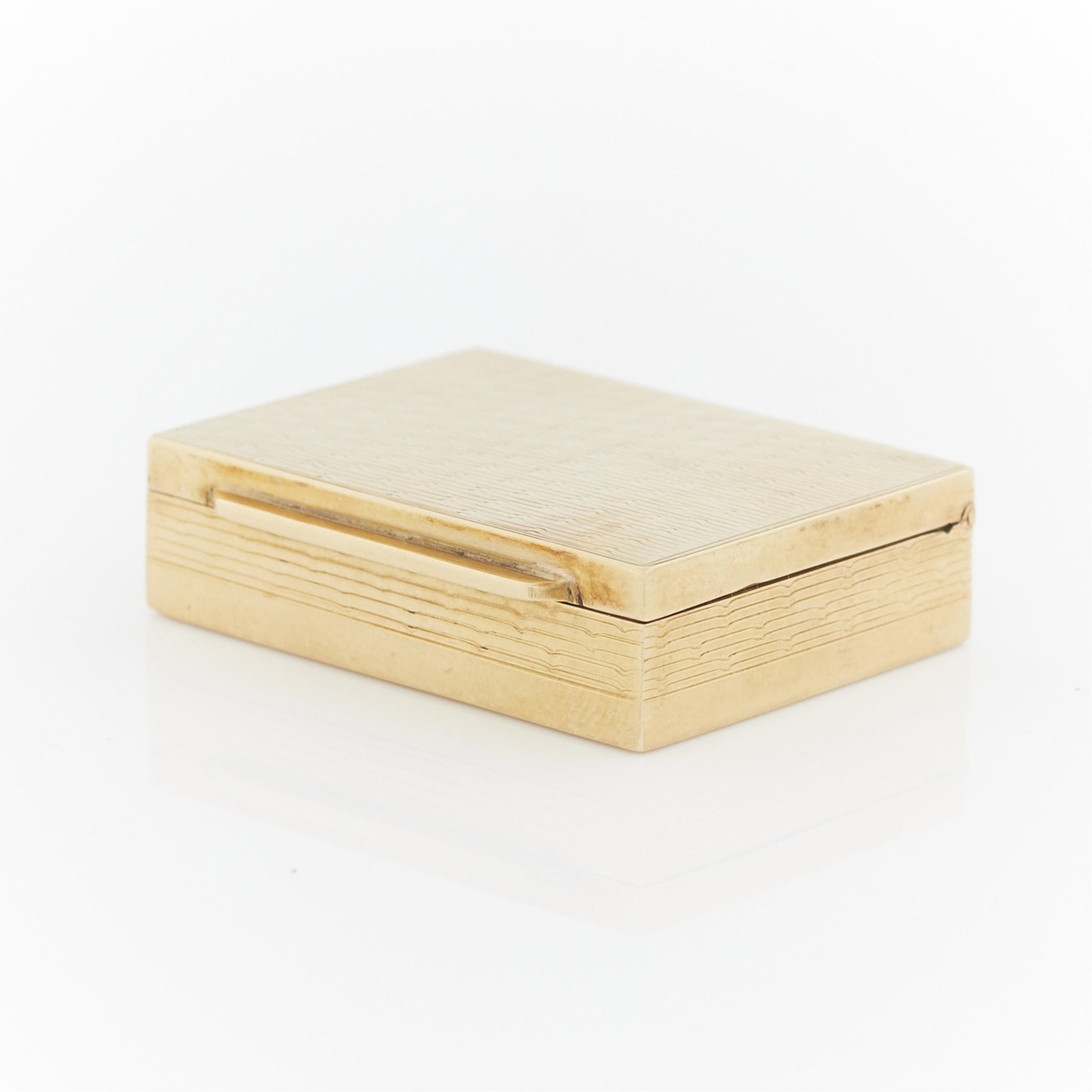 Dutch Silver Gold Plated Box: A small silver and yellow gold plated box with machined decoration and pull tab opening. The interior of the box lid marked with initials. The underside of the opening tab marked with Netherlands lion