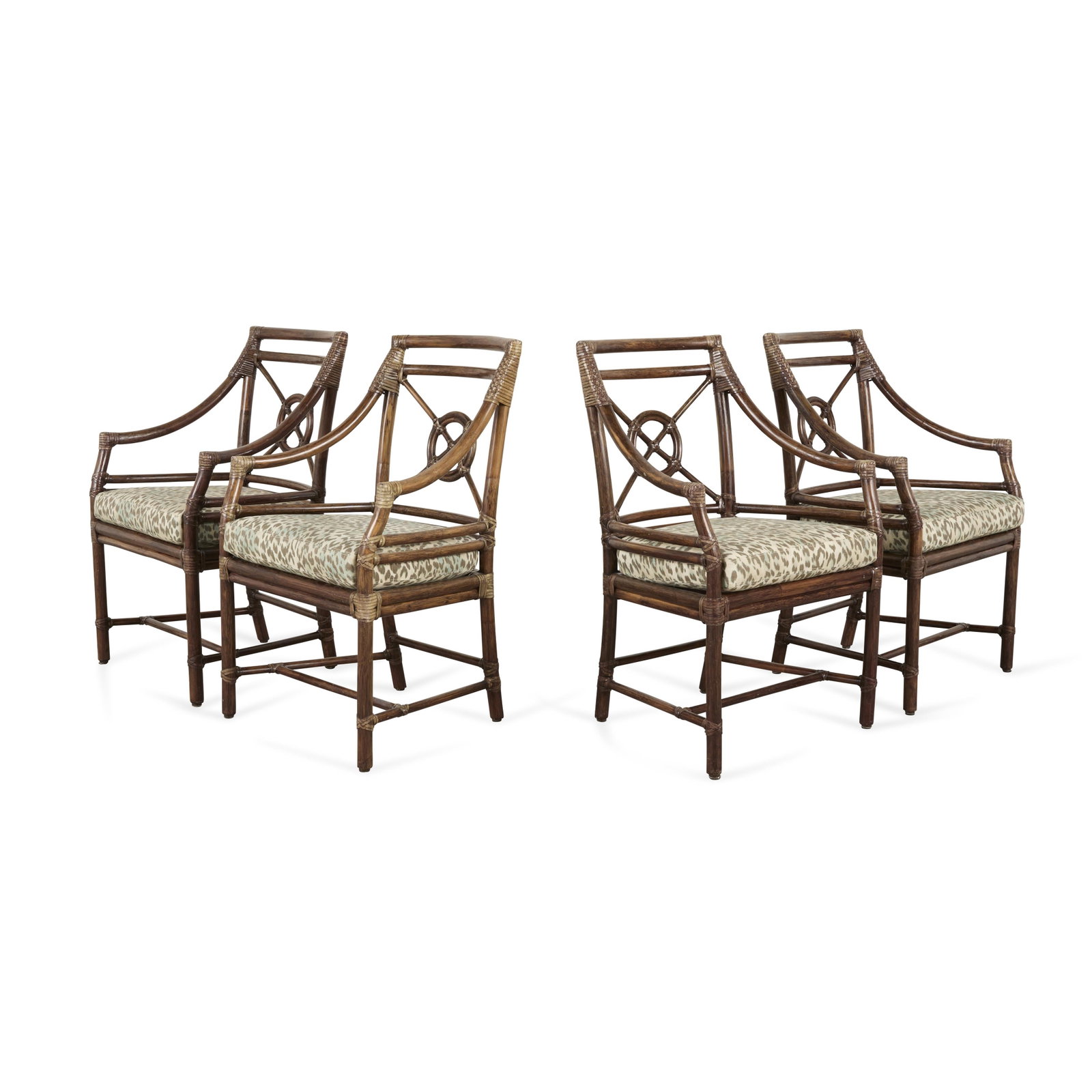 4 McGuire Furniture Mid-Century Rattan Arm Chairs: McGuire, United States. Set of four mid-century arm chairs featuring rattan frames, backsplats with McGuire's signature "Rattan Target" design, and upholstered cushion seats, 20th century. E