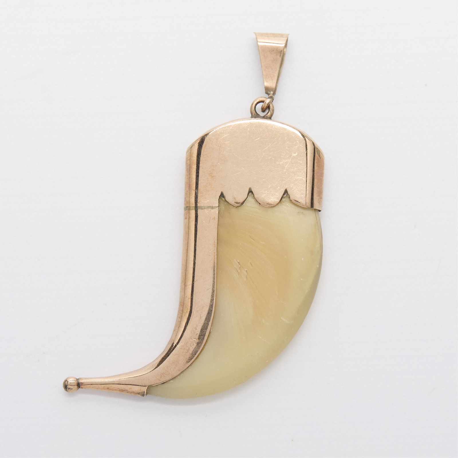 9ct Yellow Gold Claw Pendant: 9ct yellow gold pendant set with a claw. Marked along the top 9 ct. Length: 60.64 mm x width: 23.58 mm x depth: 7.38 mm; Gross weight: 8.5 g.