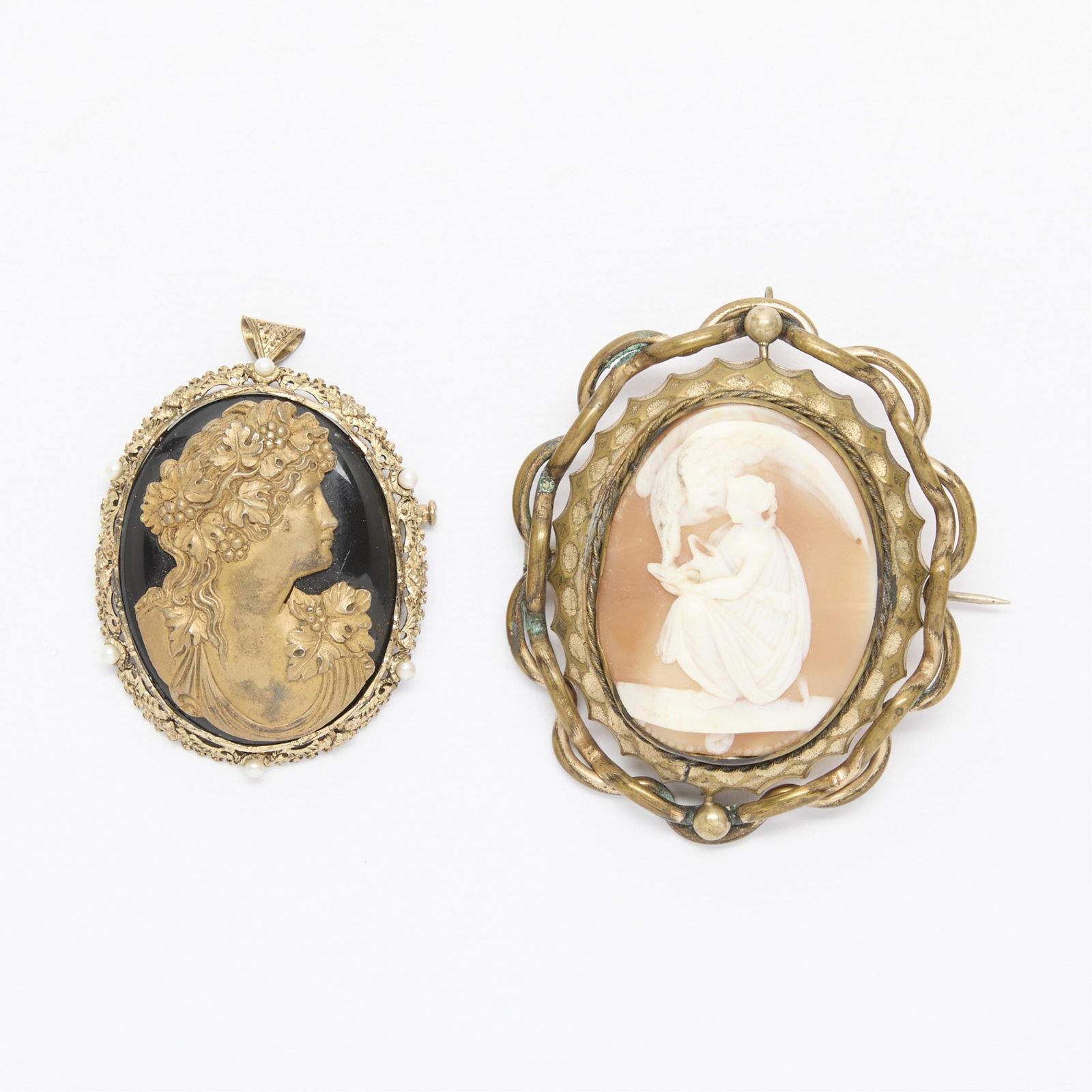 Group 2 Cameo Brooches: Group of two cameos with classical subjects, including: One large brooch in base metal with shell cameo depicting Hebe, the cup bearer of Zeus, with older C clasp closure. One large costume jewelry br