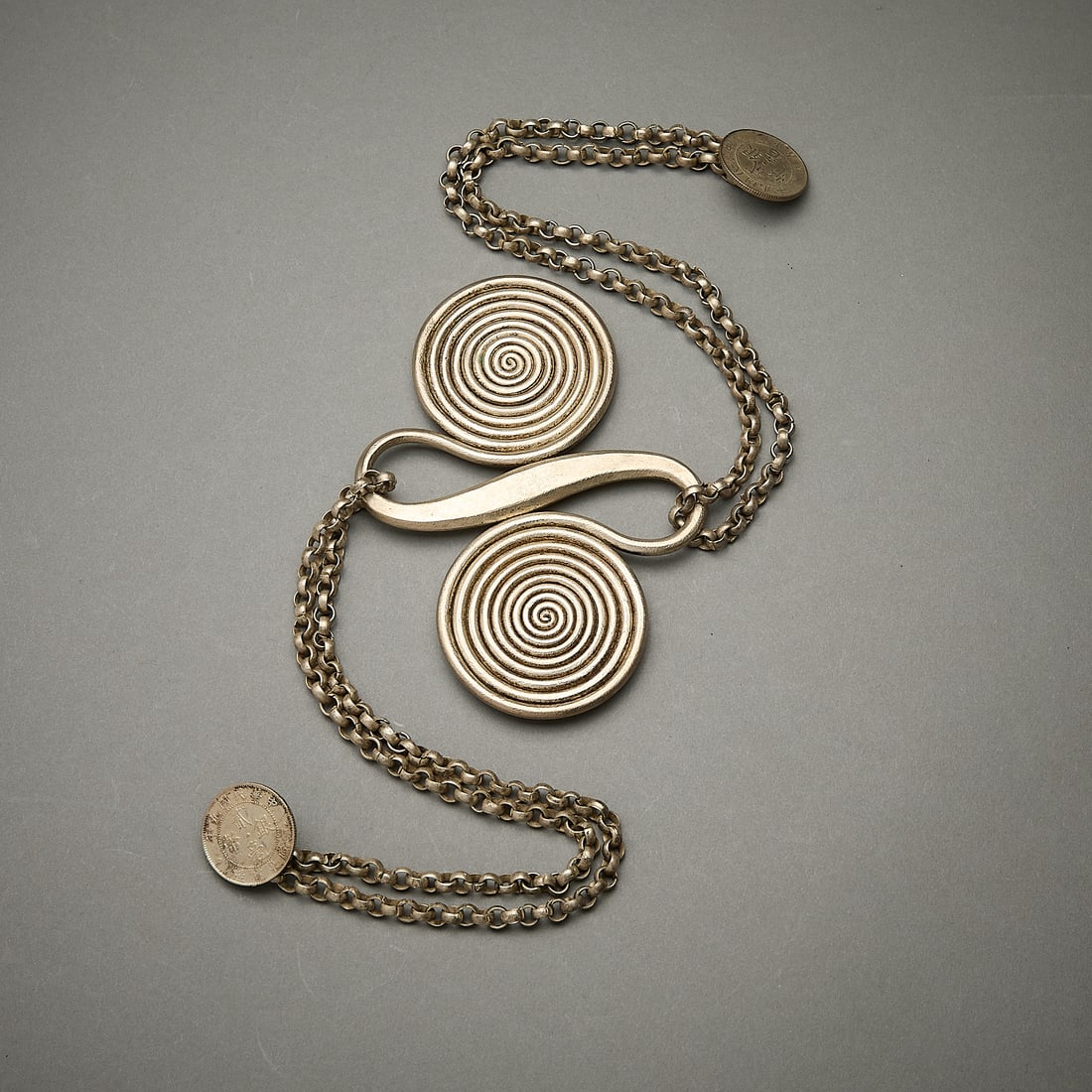 Dong or Miao Spiral Back Ornament: Back ornament from the Dong or Miao (Guizhou or Zhaoxing area). Comprised of a two connected spirals representing the never ending cycle of life. the center connecting the two spirals attached on eith